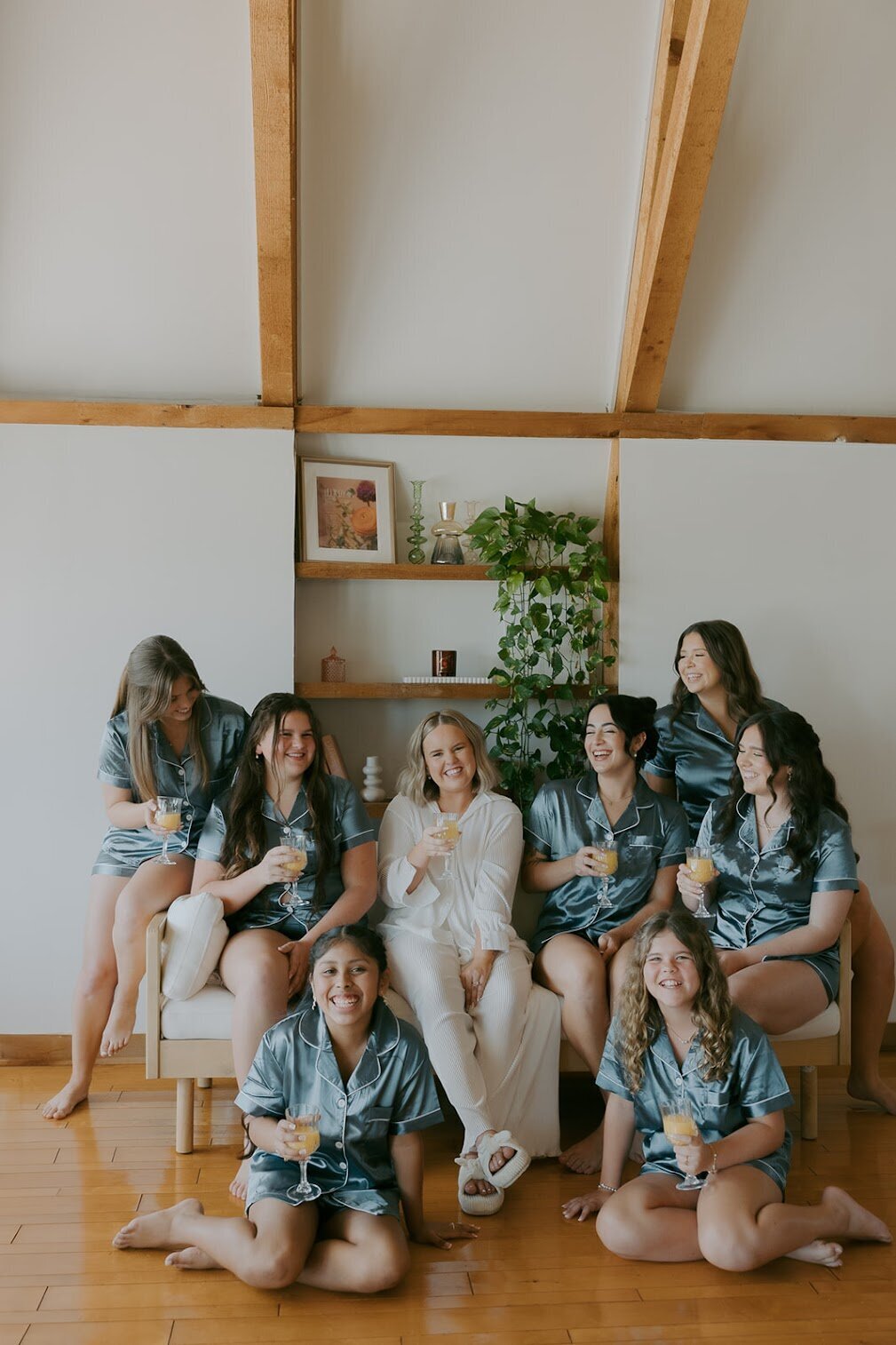 Bride and bridesmaids in matching pajamas celebrating and relaxing in the bridal suite at Uliana Estate in Lakeland, Florida

