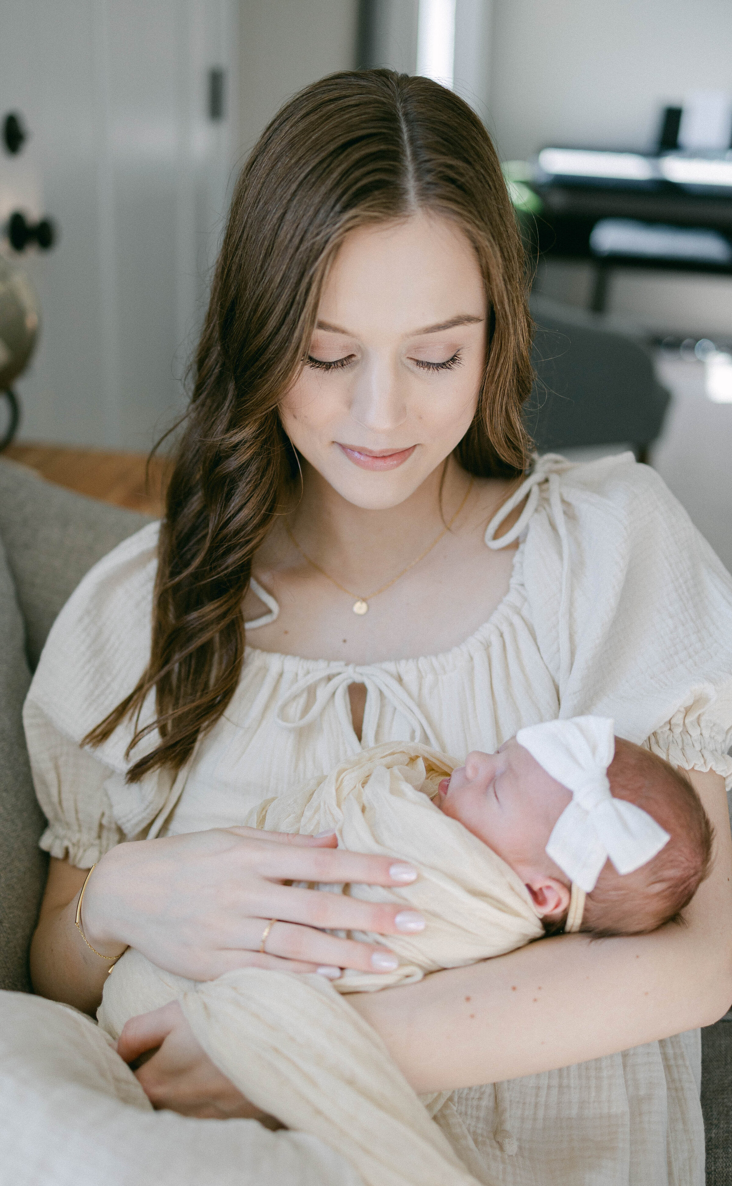 women holding swaddled baby smiling down at baby  knoxville tennessee newborn photographer