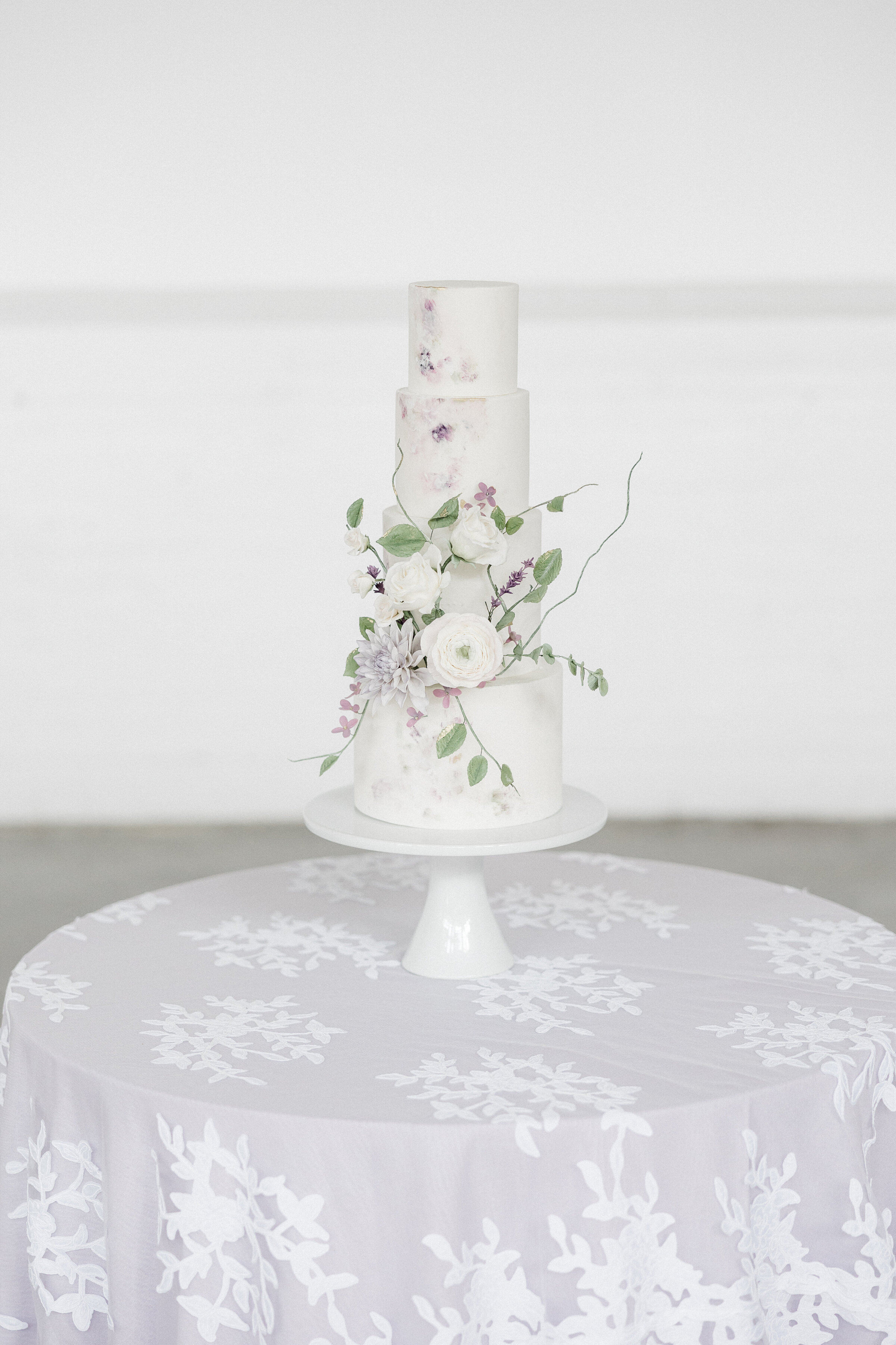 wedding cake on table with purple table cloth