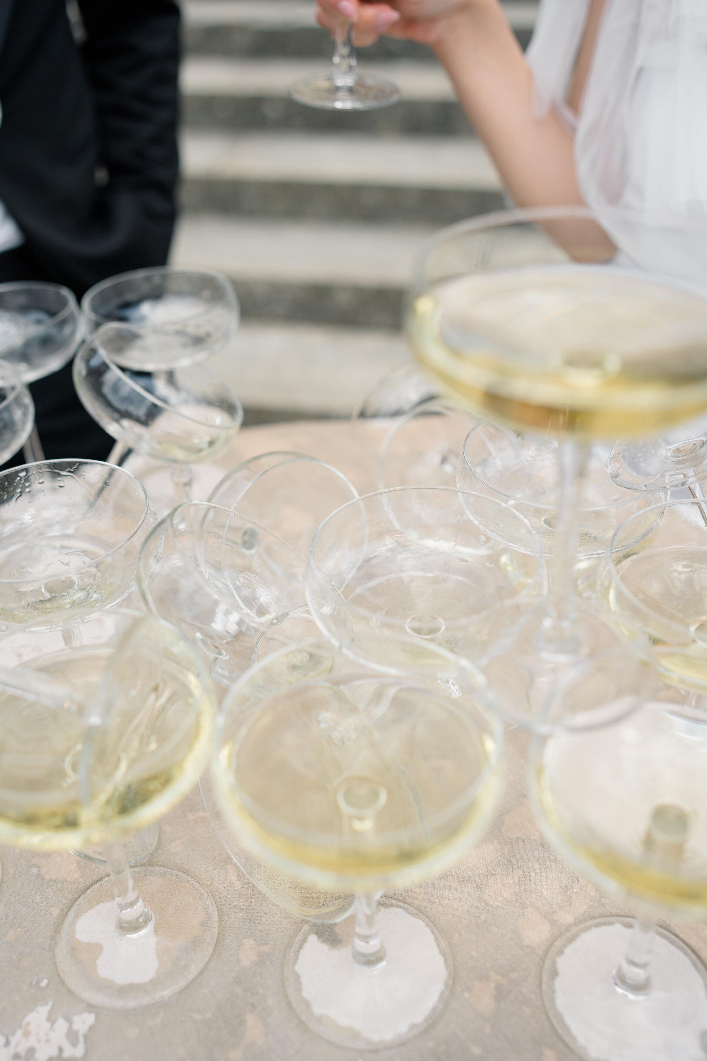 Wedding and Elopement Photographer, detail shot of glasses getting ready for toast
