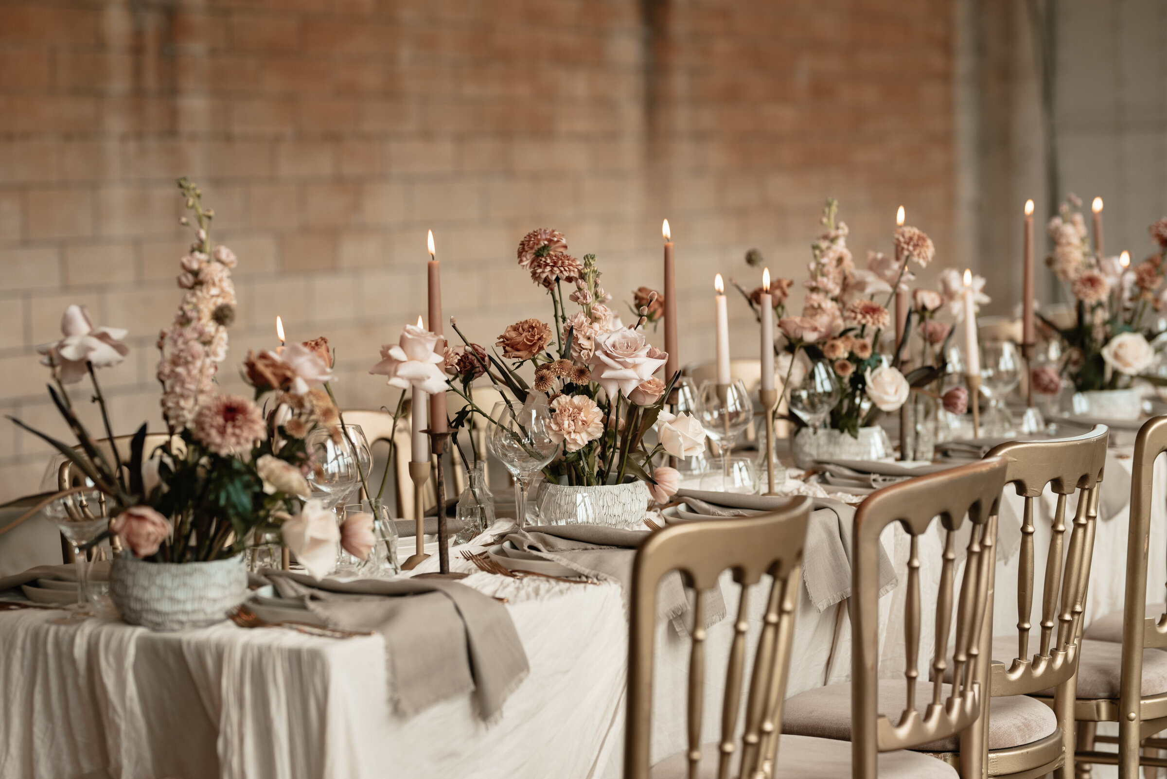 Wedding breakfast table with floral and candle stick arrangements at Grittleton House wedding venue in Wiltshire