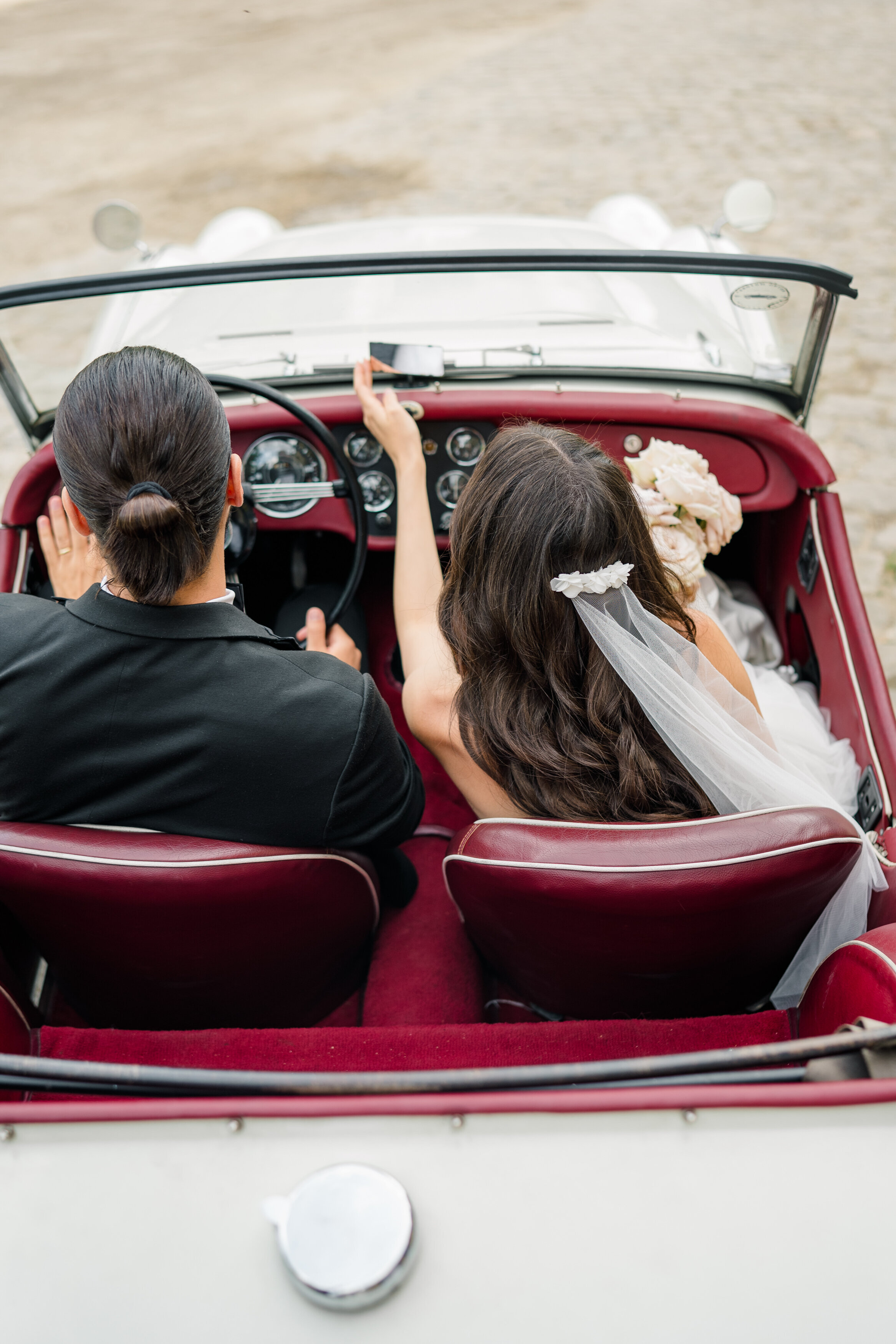 Wedding and Elopement Photographer, above shot of couple in getaway car