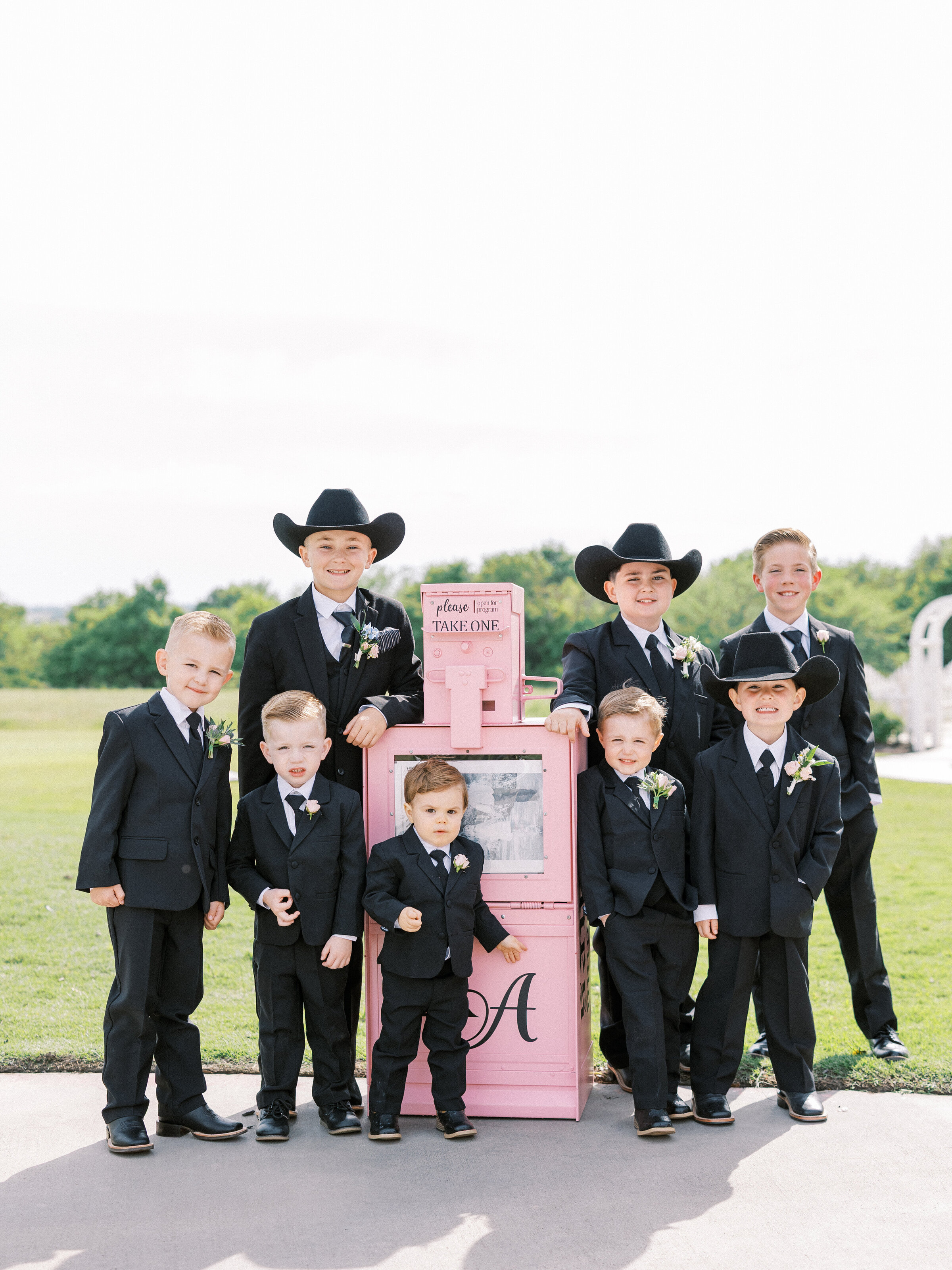 Little boys with pink newspaper stand