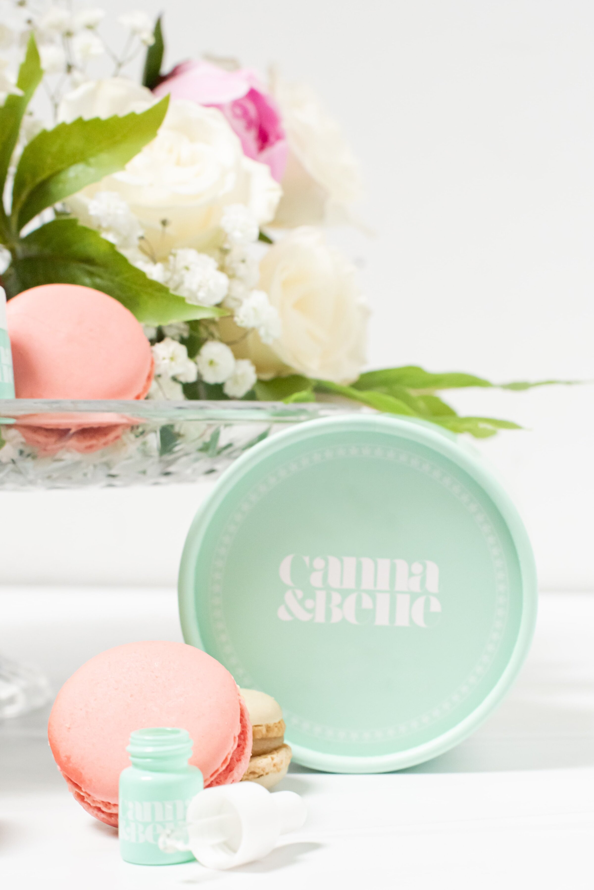 CBD drops styled with flowers and macarons