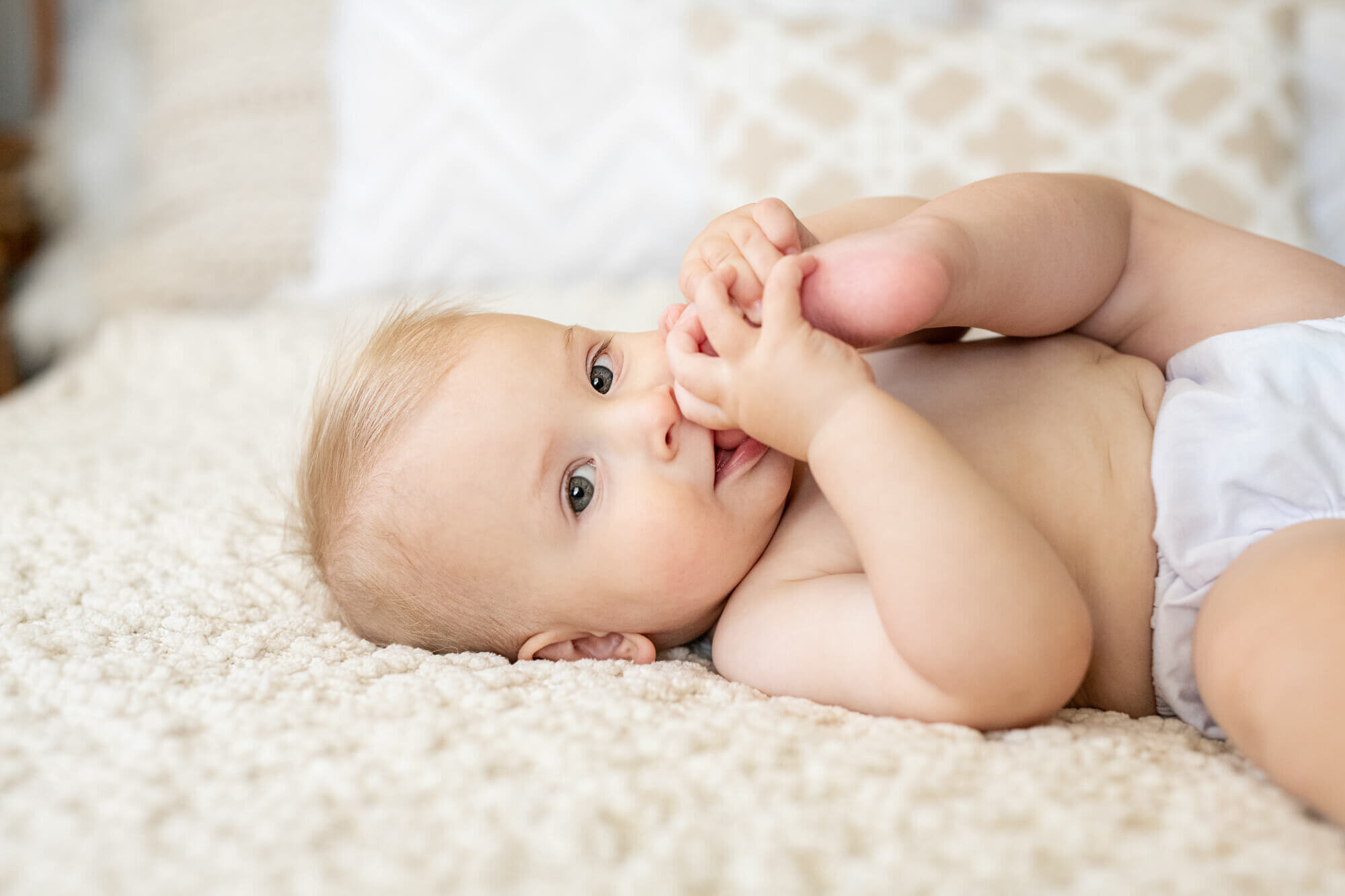 Baby biting toes