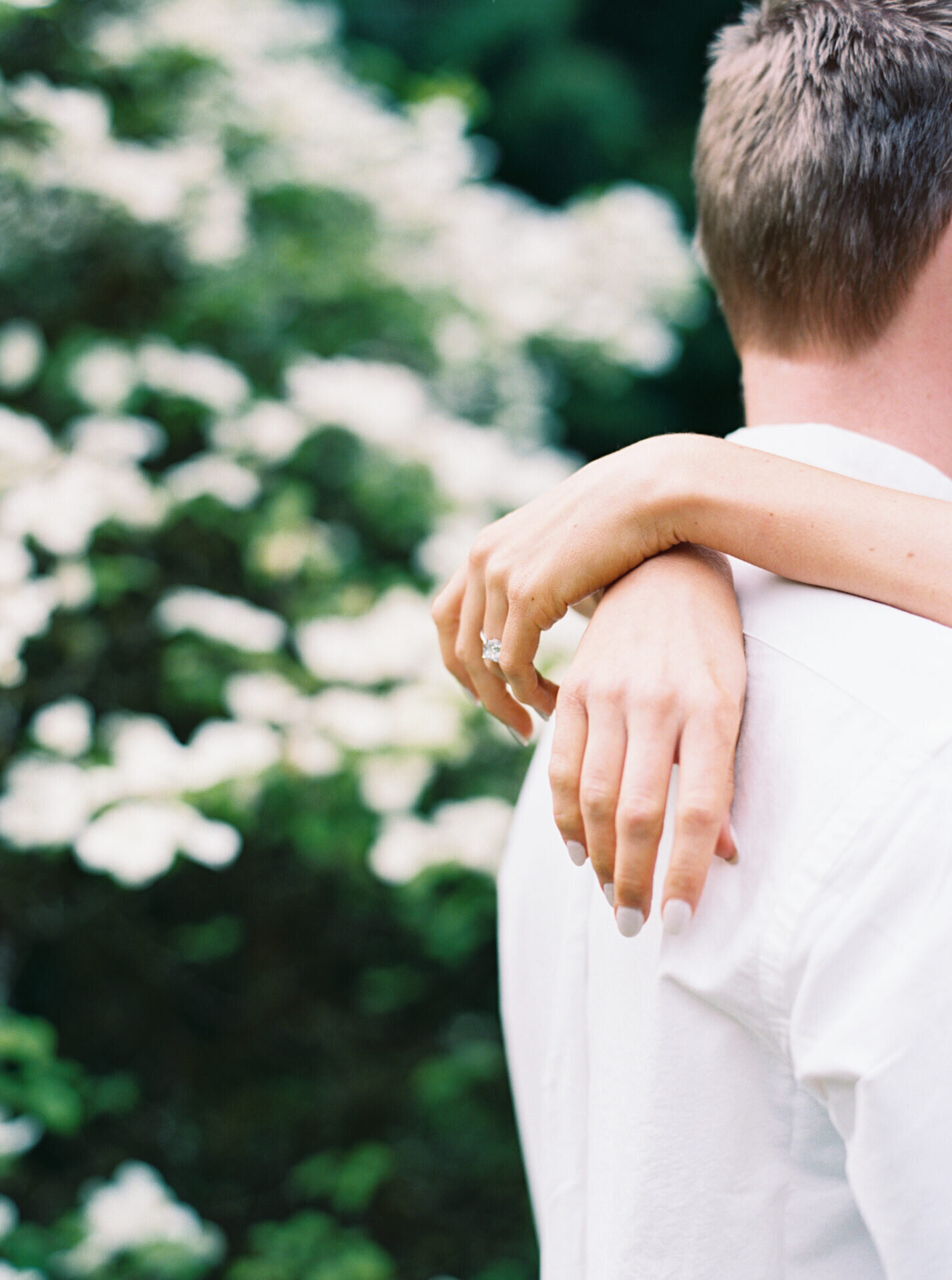hands of woman hanging over her boyfriend