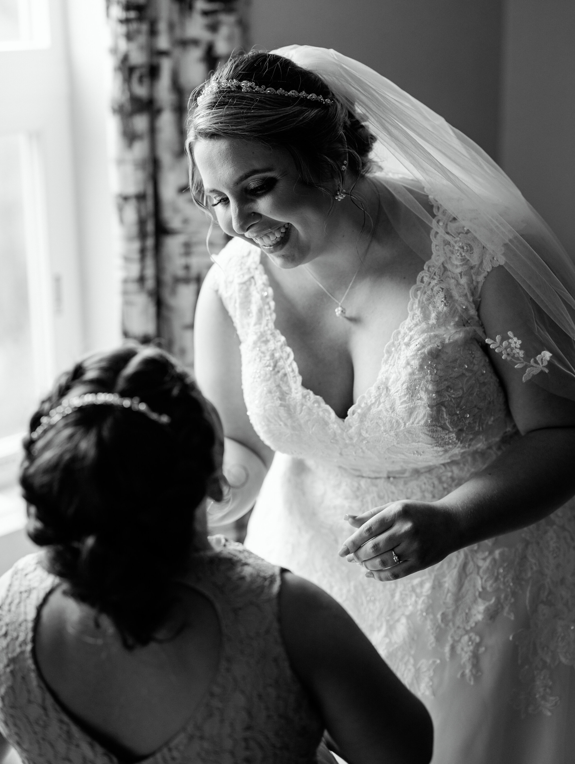 Bride sprays perfume on her daughter as they get ready for wedding ceremony in New Hampshire