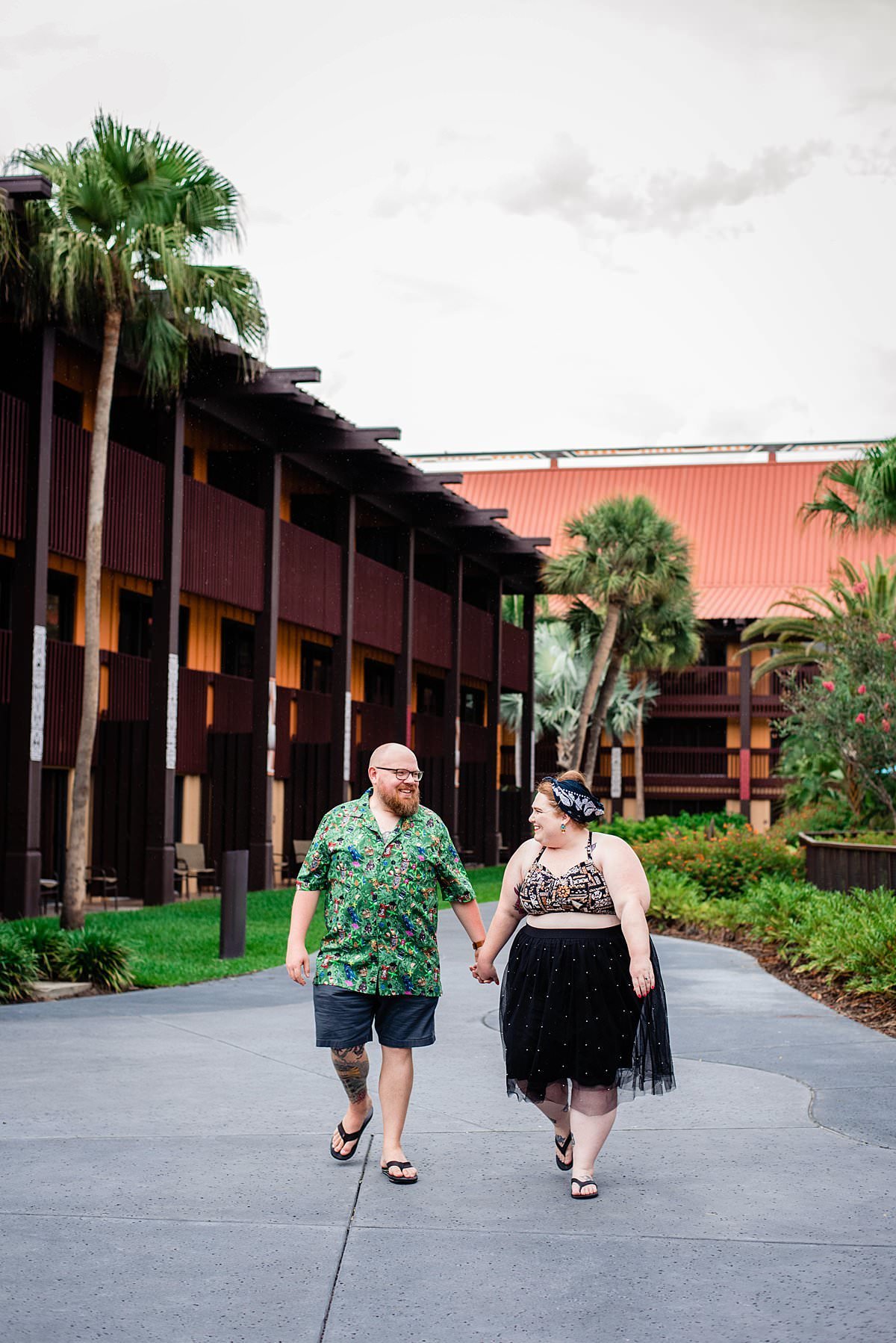 Girl with the Dolewhip Tattoo holding her husbands hand and strolling near the pool at Disney World Polynesian Resort