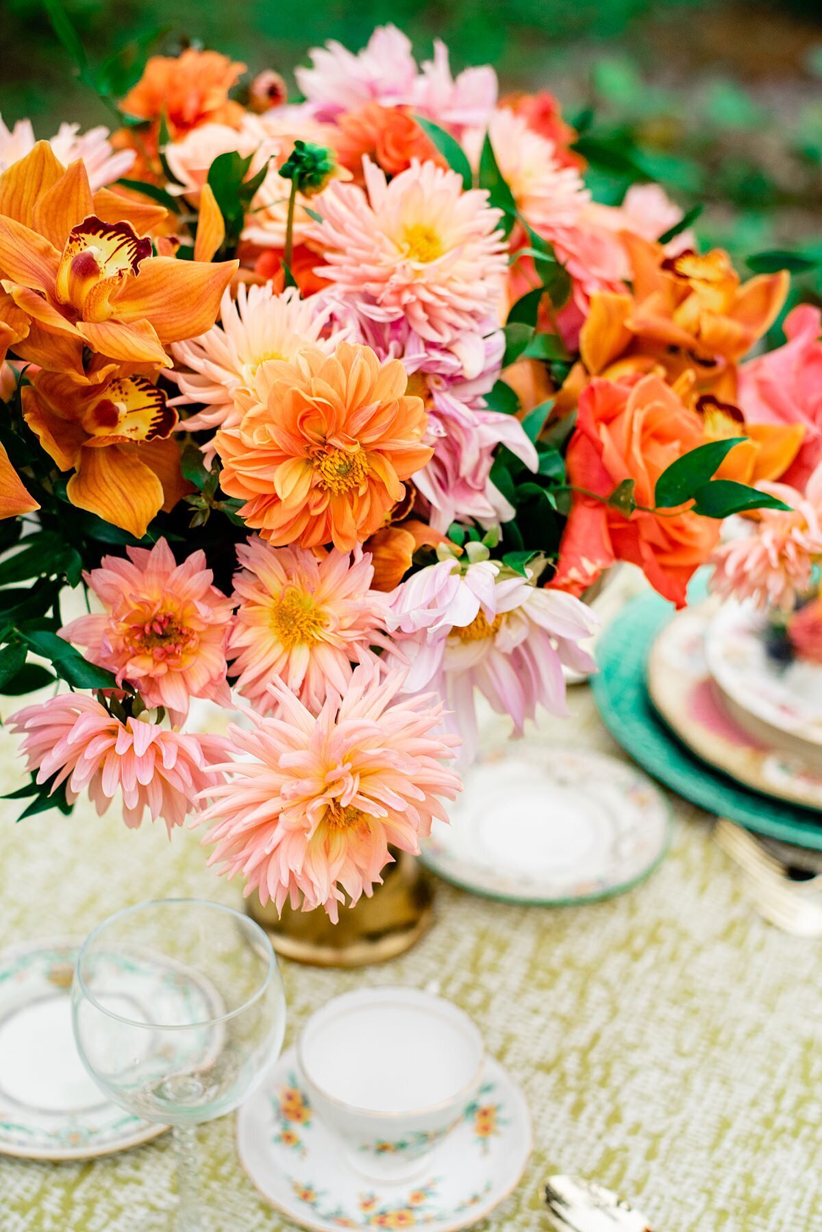 Compote with orange, pink lush flowers for a floral heavy compote centerpiece