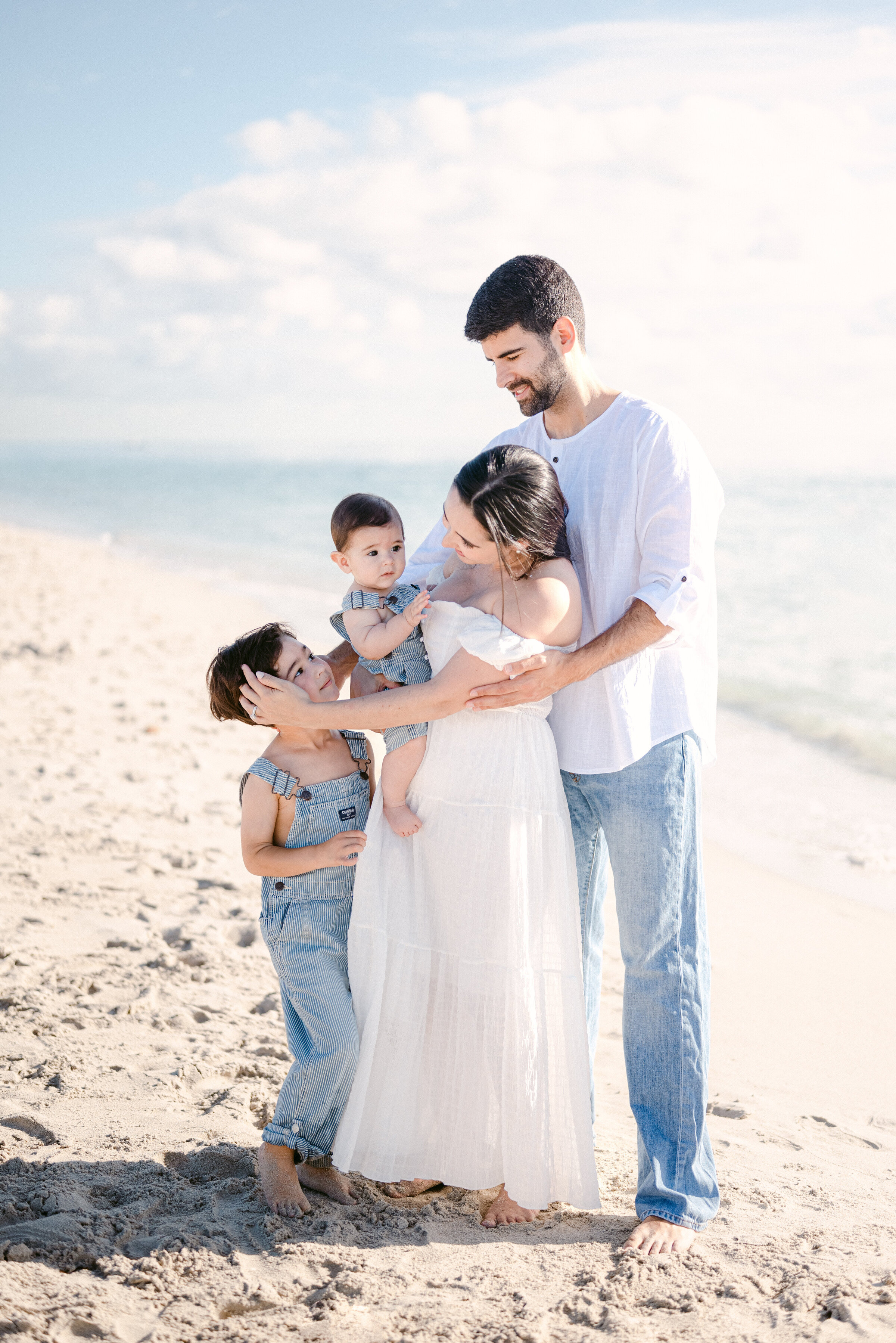 family of 4 enjoying their time on the beach in miami