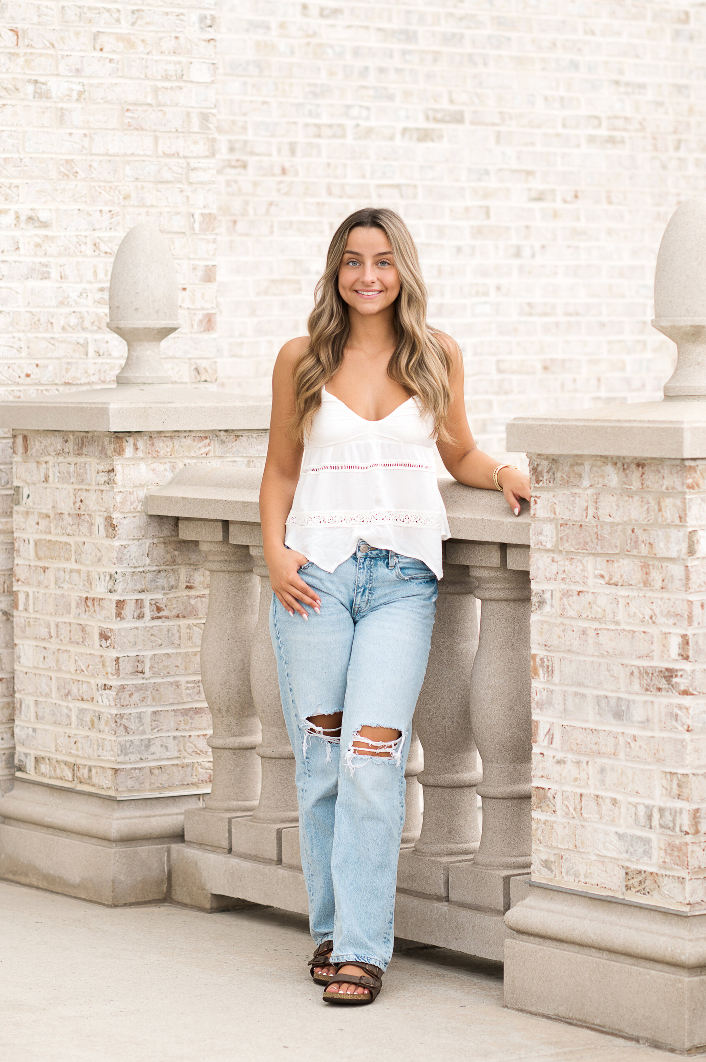 High school senior leaning on stone railing at Hershey Gardens near York, Harrisburg, and Lancaster PA.
