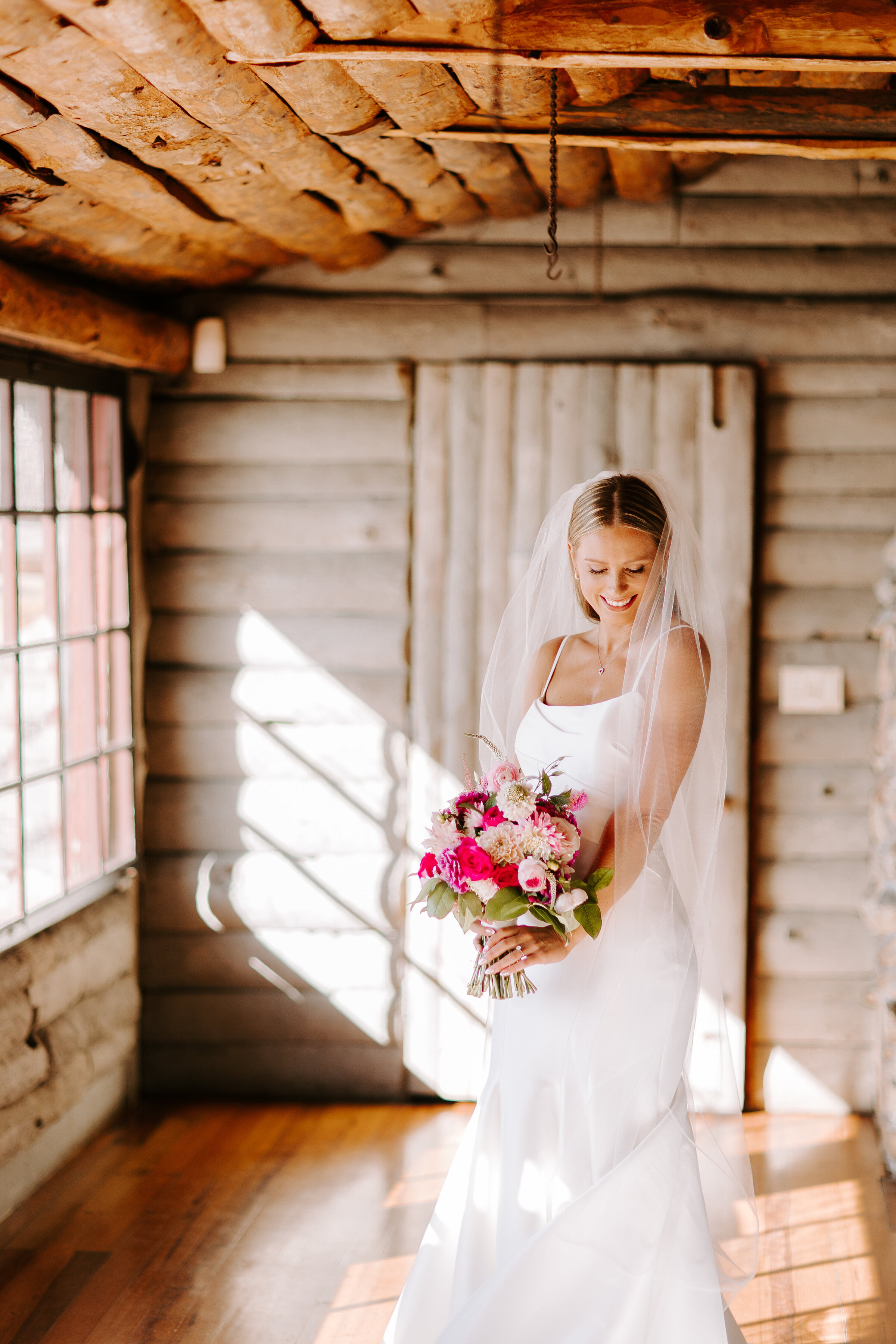 Bride looks down at her bouquet before wedding ceremony at mount hope farm in Bristol, RI