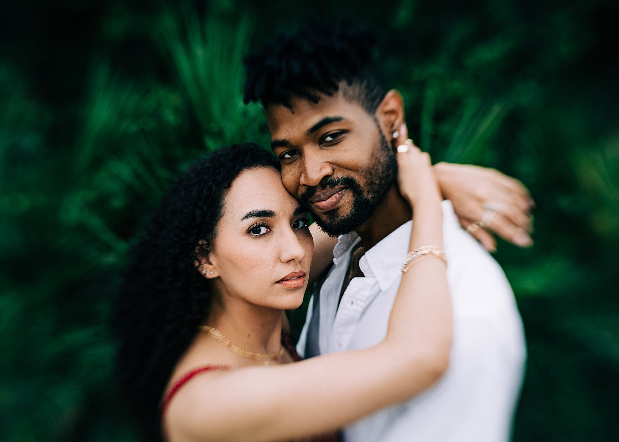 Couple hugging and looking at the camera smiling