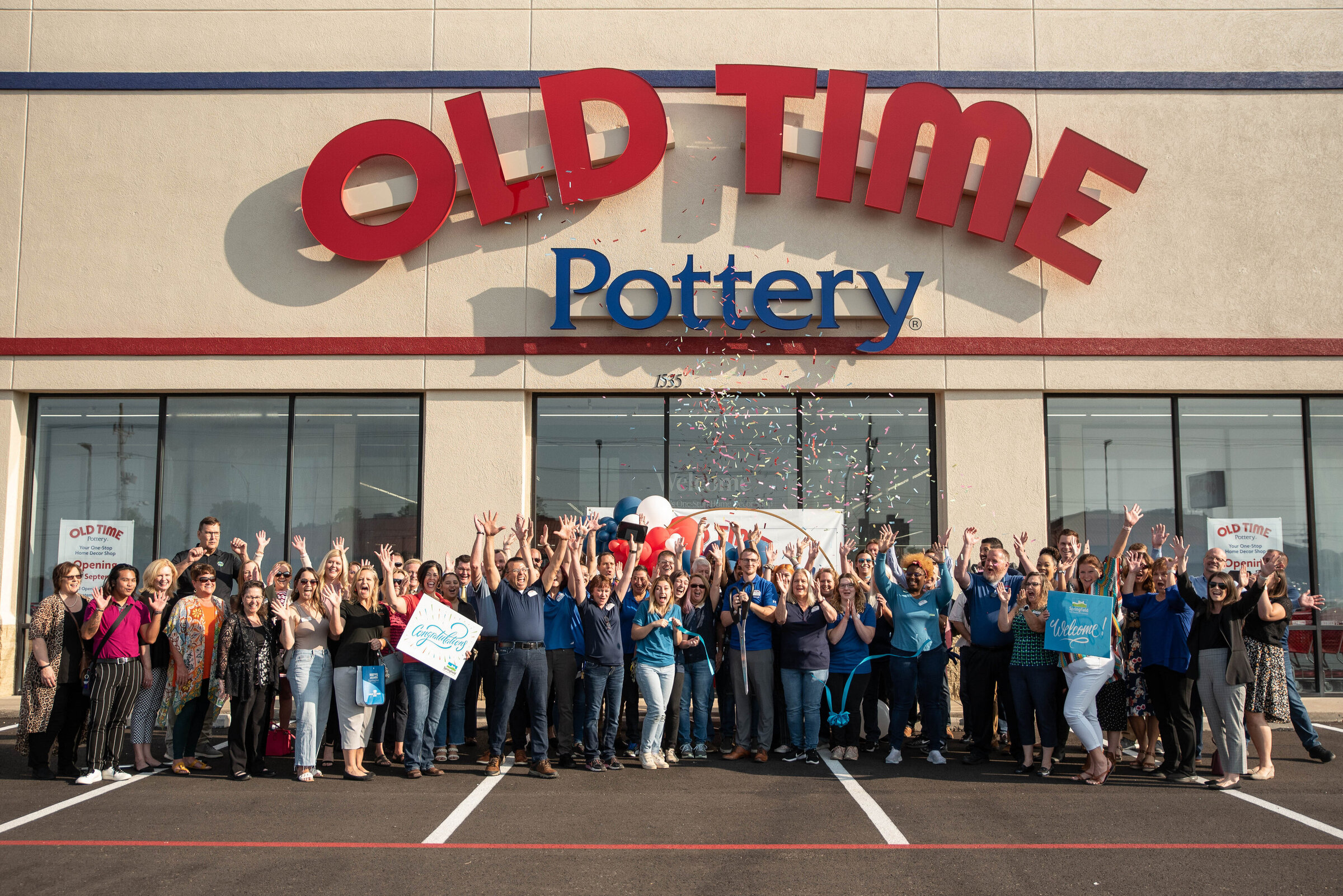 Employees at Old Time Pottery in Springfield, MO celebrate their grand opening with corporate photos and event photography from Gambles