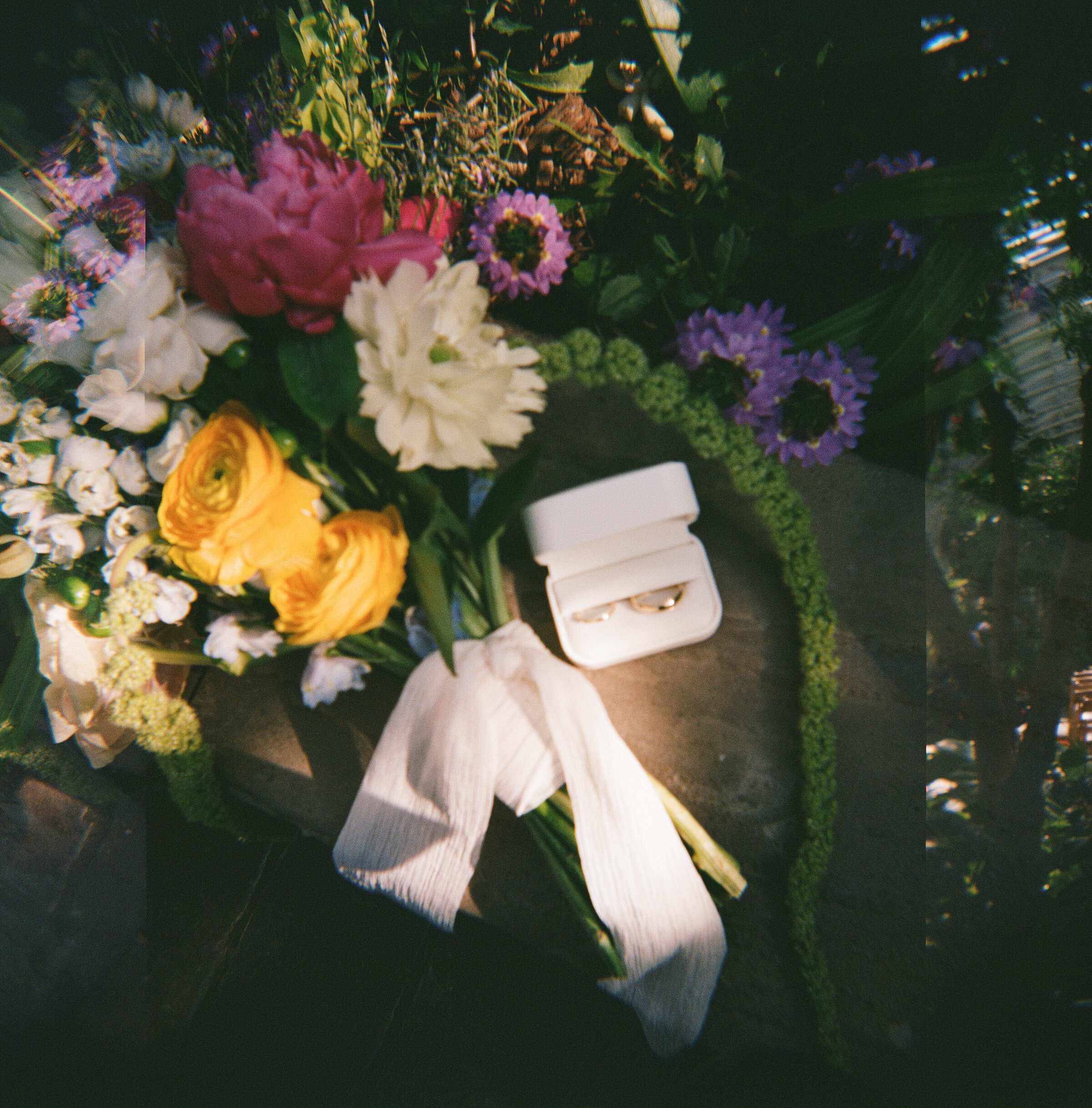 Colorful close-up of wedding rings and details at a Chicago wedding, captured in a film-style editorial by Emily Ambie.