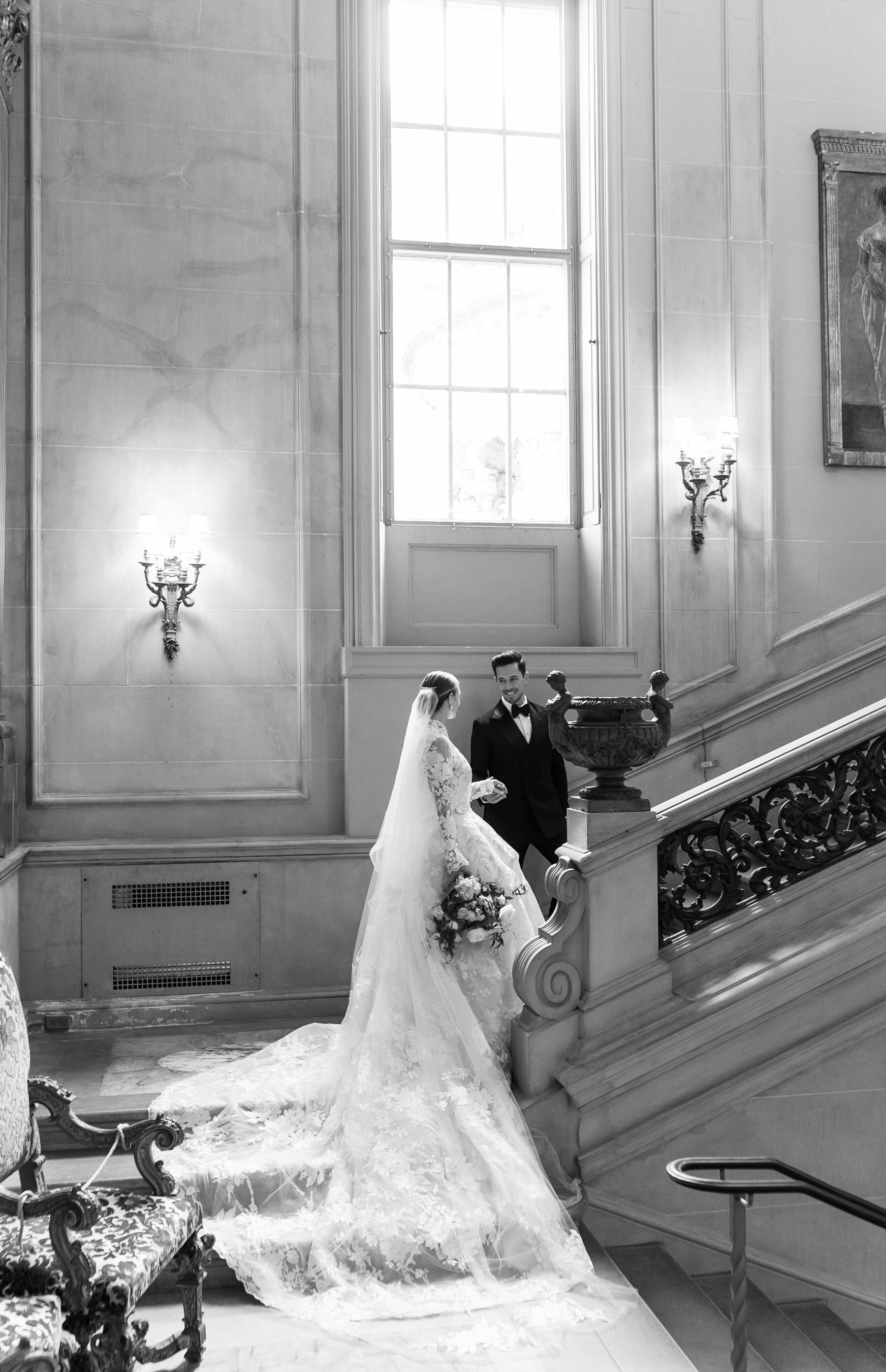 classic bride and groom on an elegant marble staircase