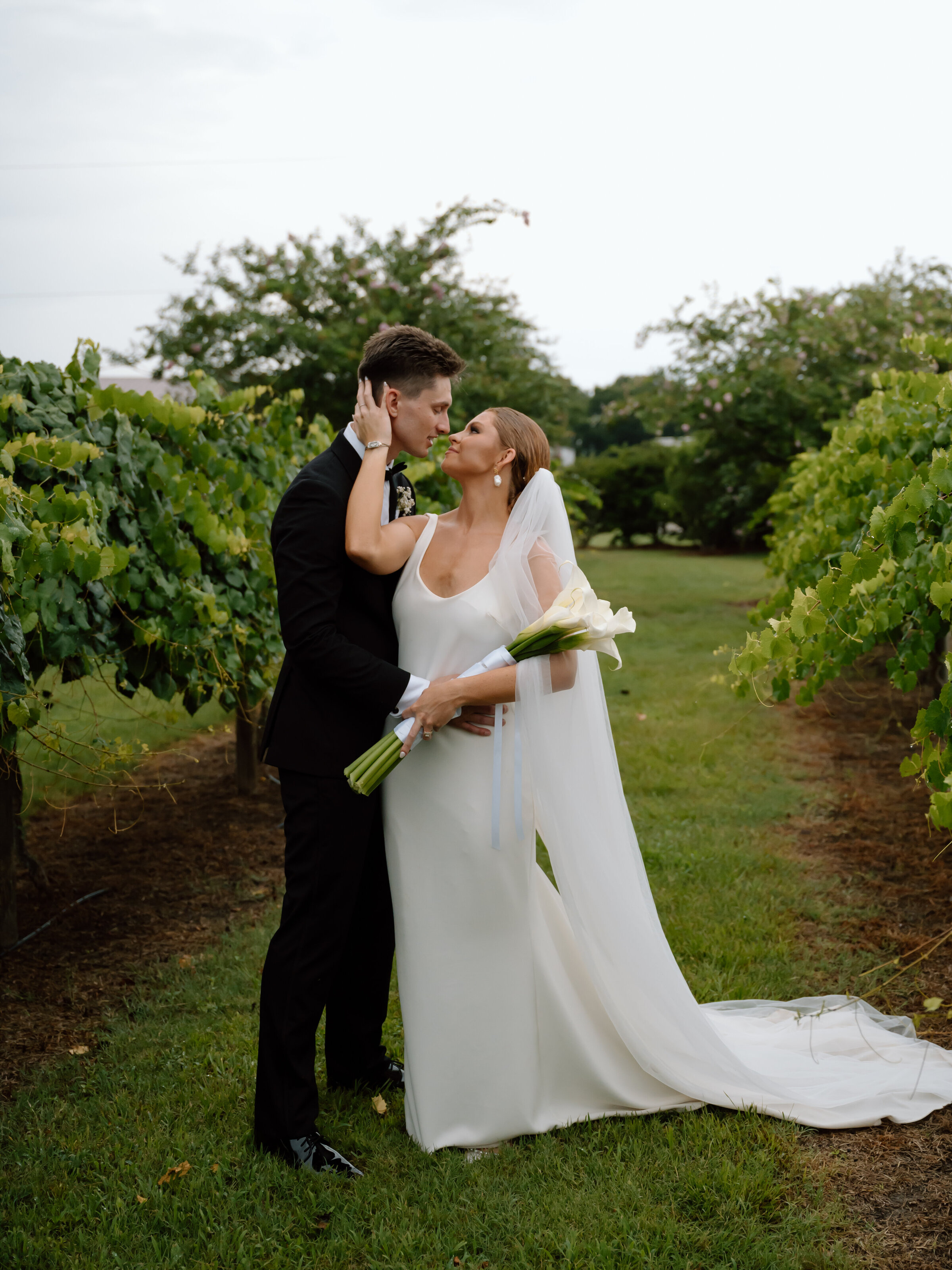 a bride and groom embracing at the Tuscan Rose Vineyards in Jacksonville, FL