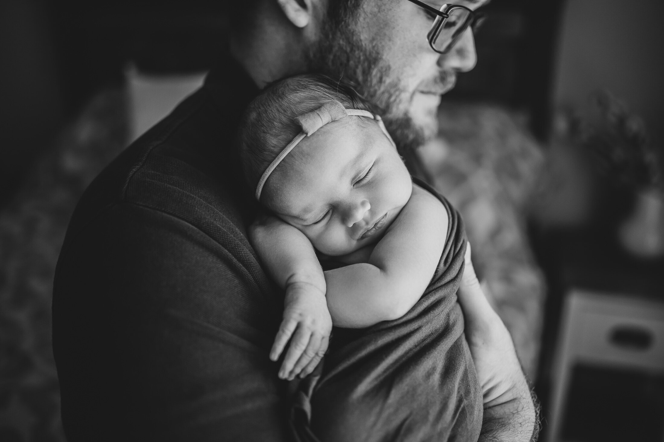 Dad holding newborn daughter