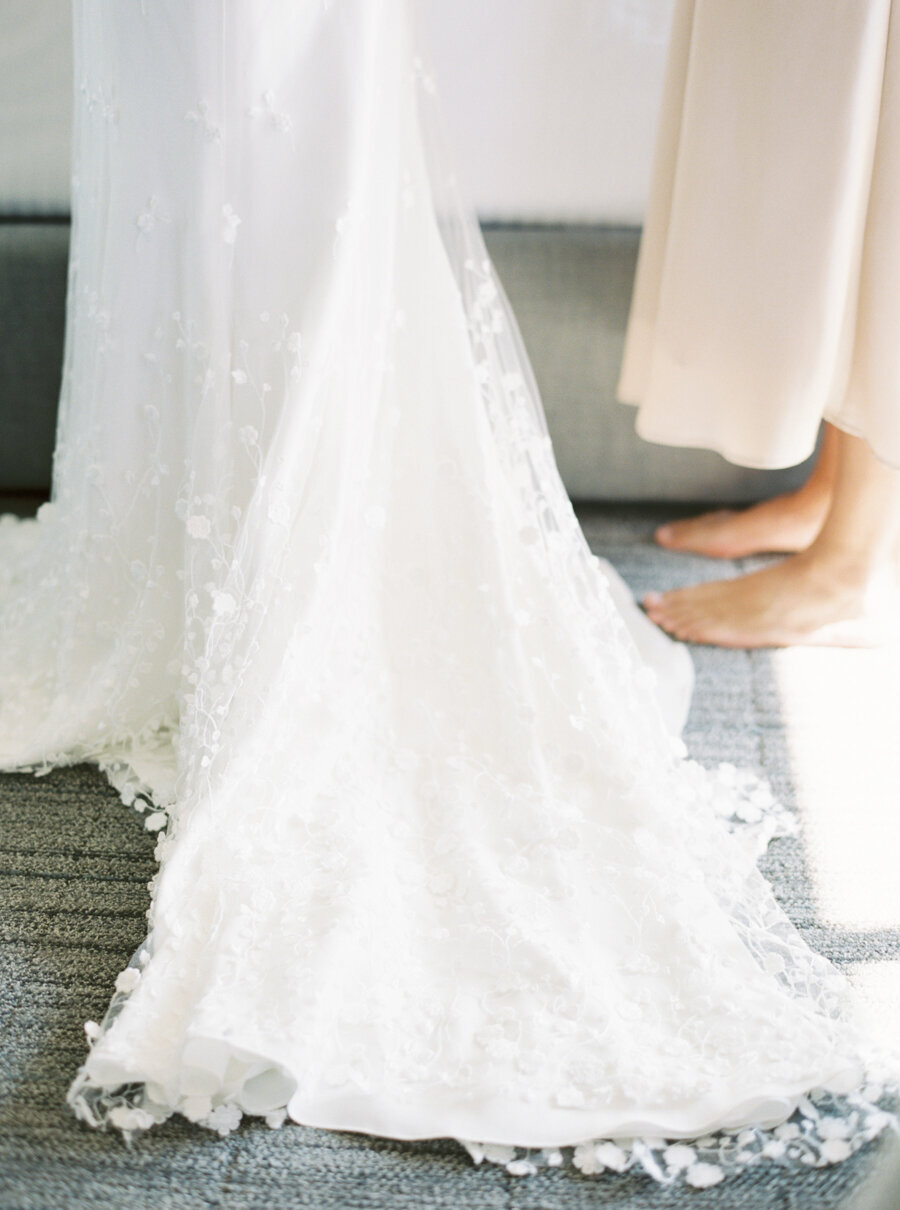 textures overlay on brides gown lays on the floor while she wears it