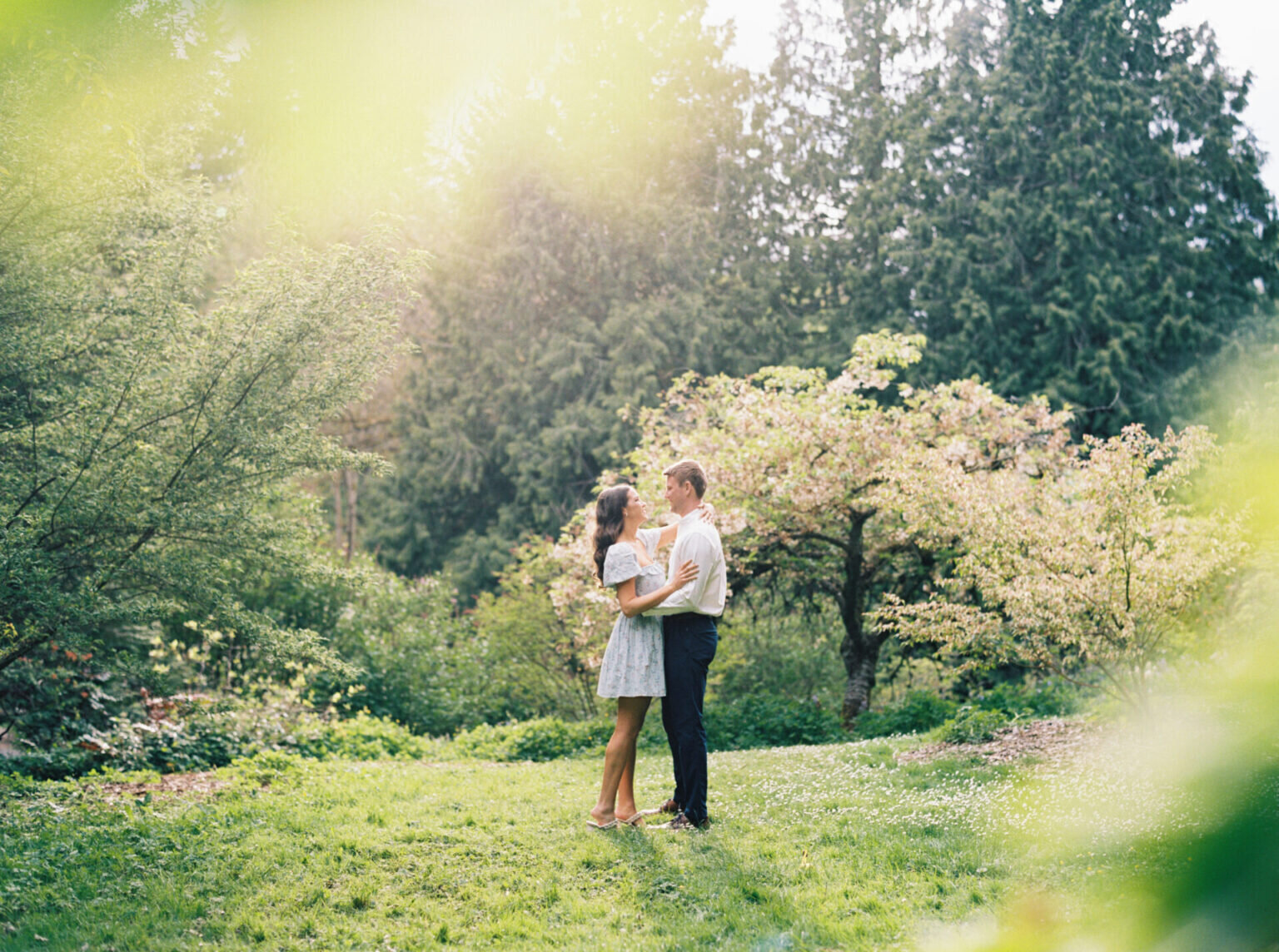 horizontal image of couple embracing each other in green park