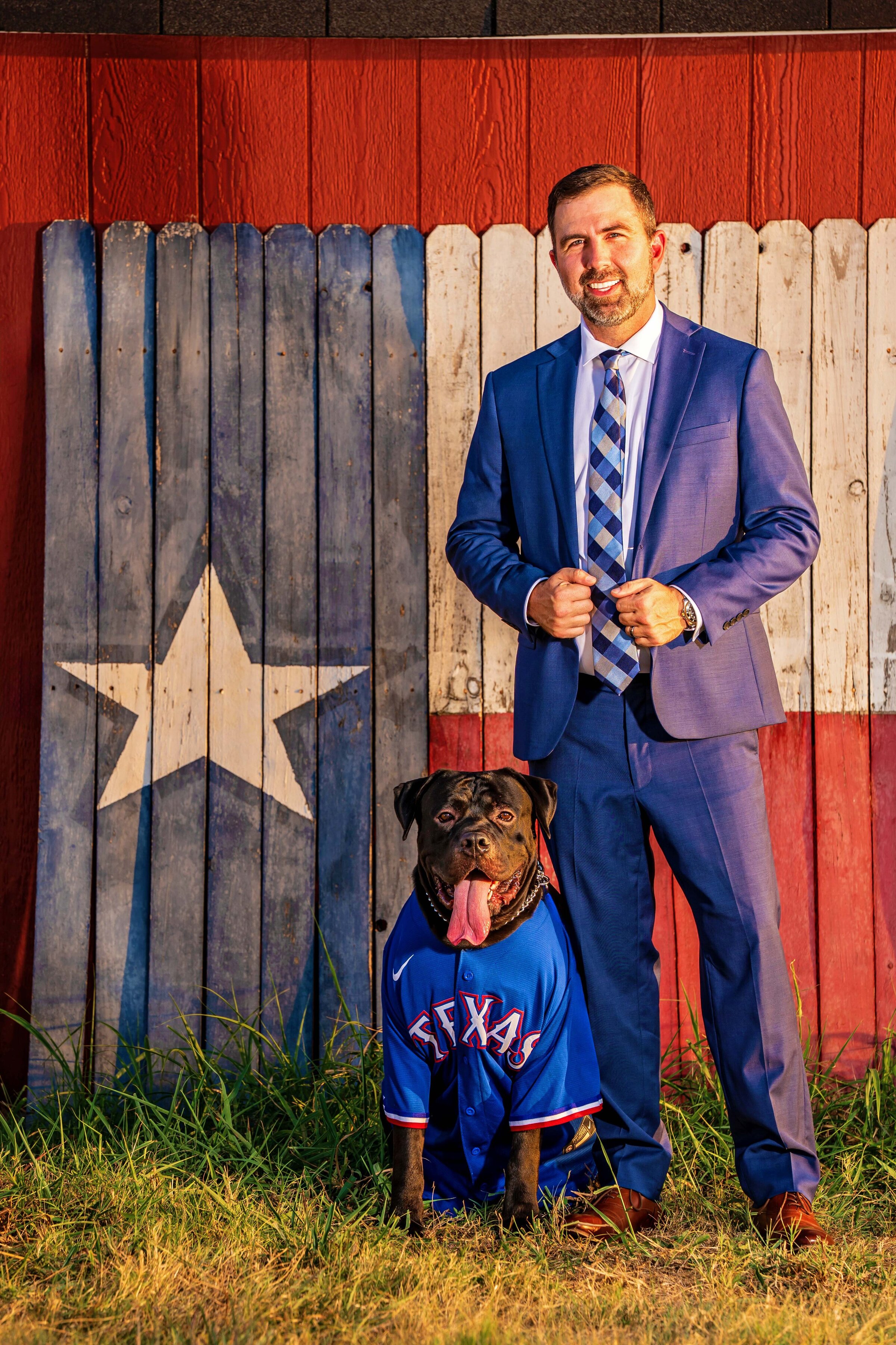 man in suit with dog in Texas Rangers jersey