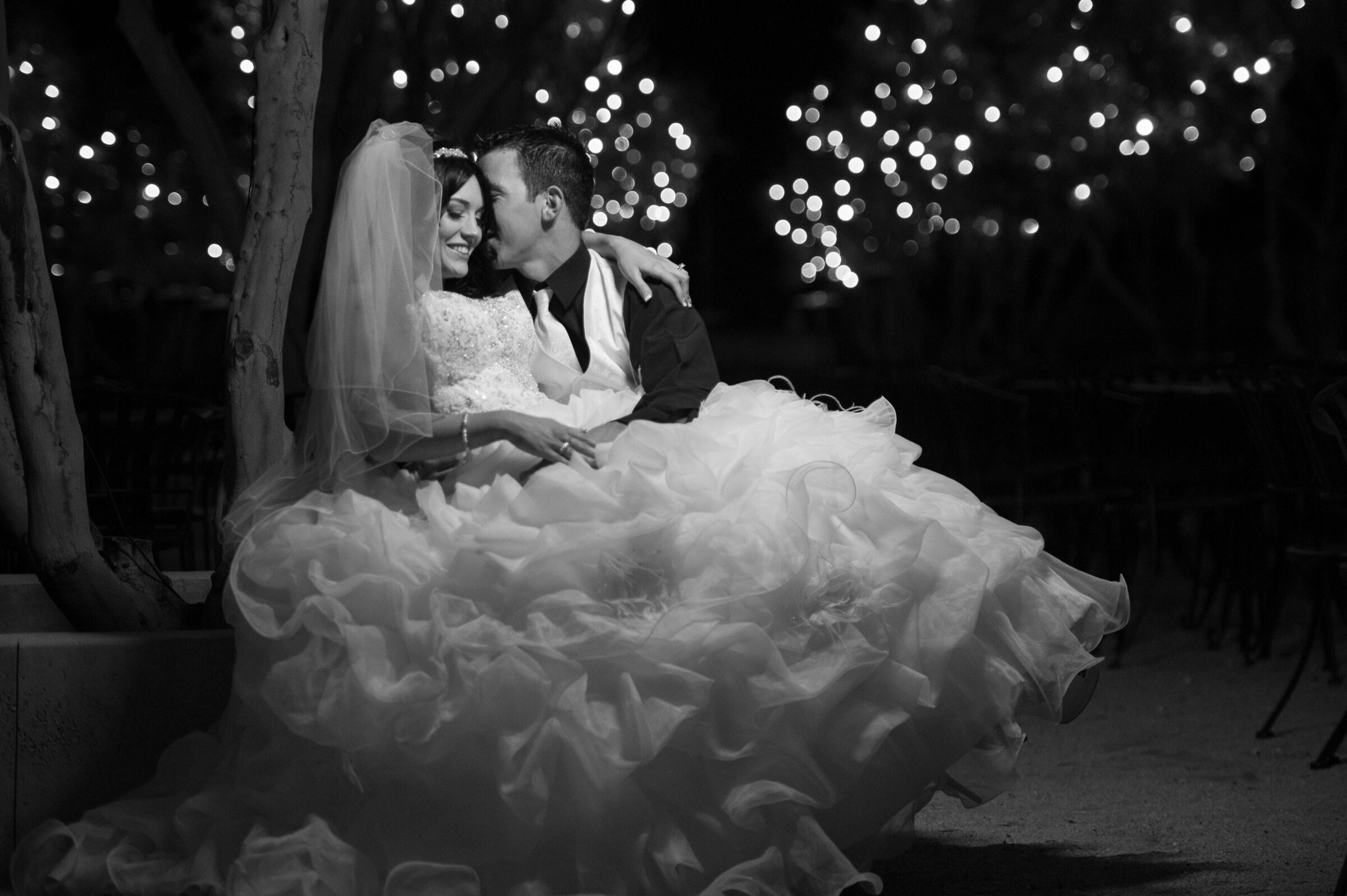 bride-groom-intimate-lap-kiss-fairy-lights-