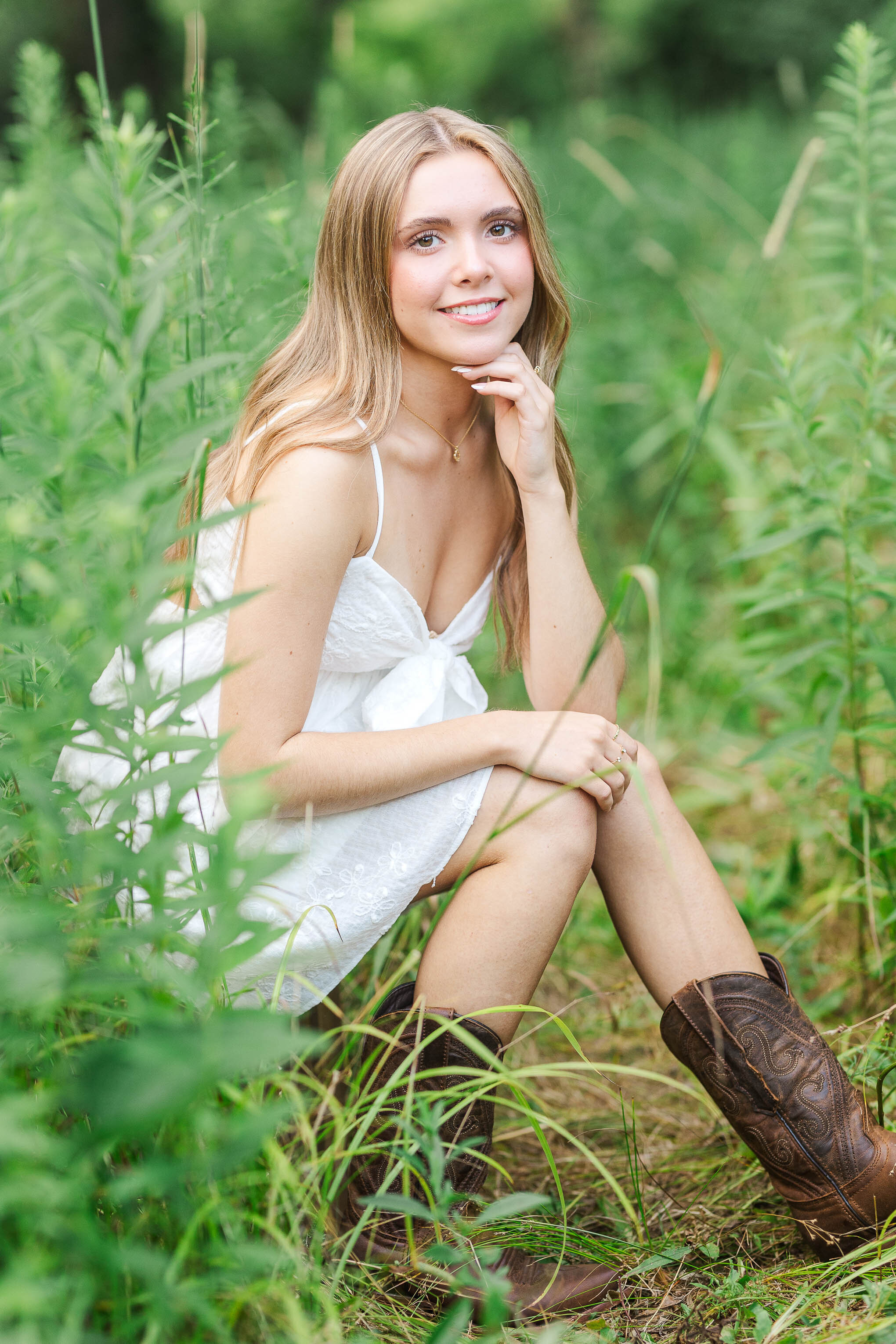 Columbus senior photos at Inniswood Metro Park – a beautiful high school senior sitting by vibrant flowers, captured in natural light for a classic portrait