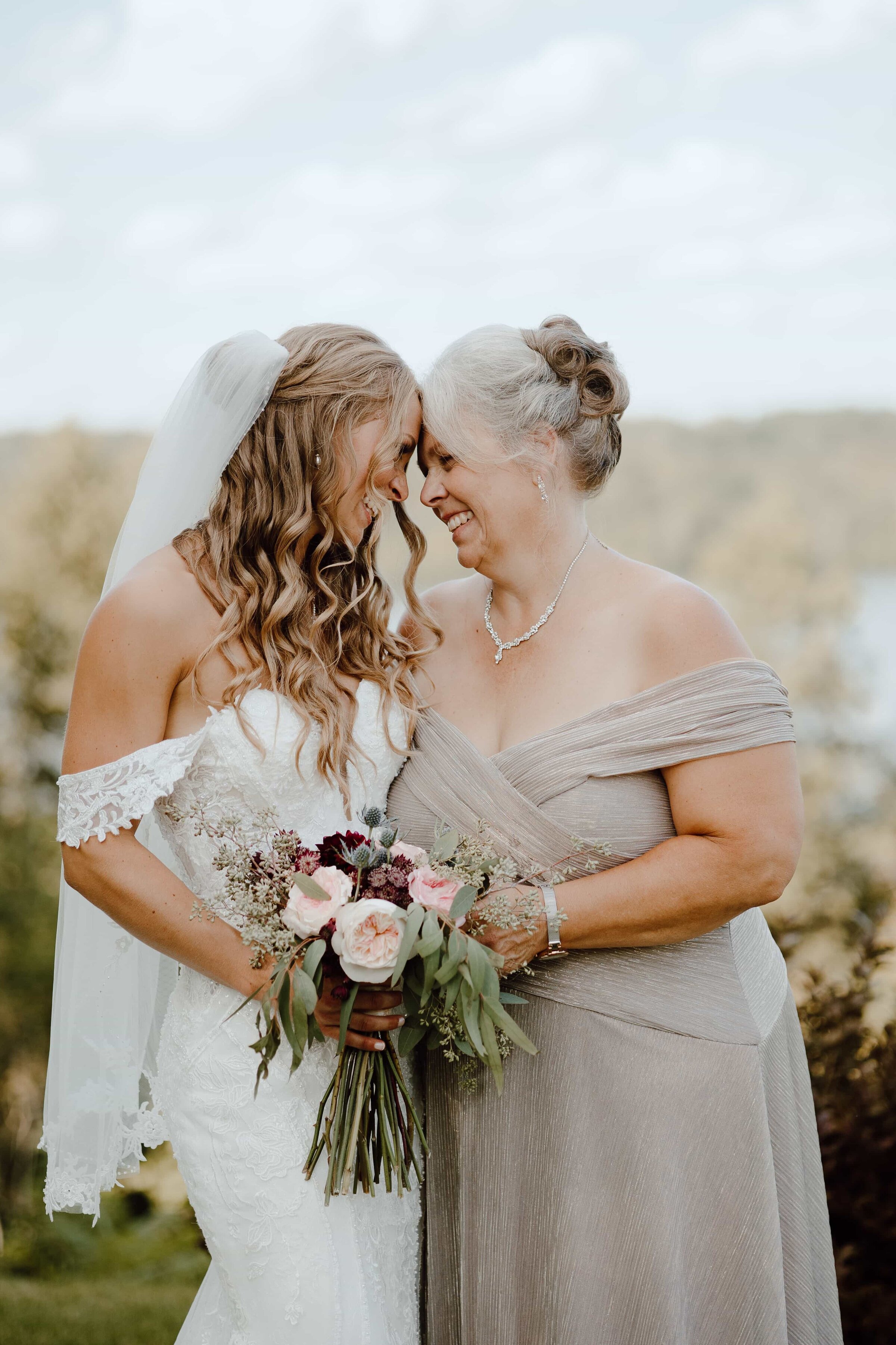 bride smiling with mother