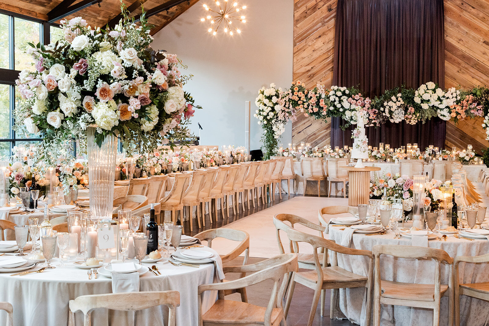Passiflora wedding flowers that includes elevated centerpieces and flowers over head table 