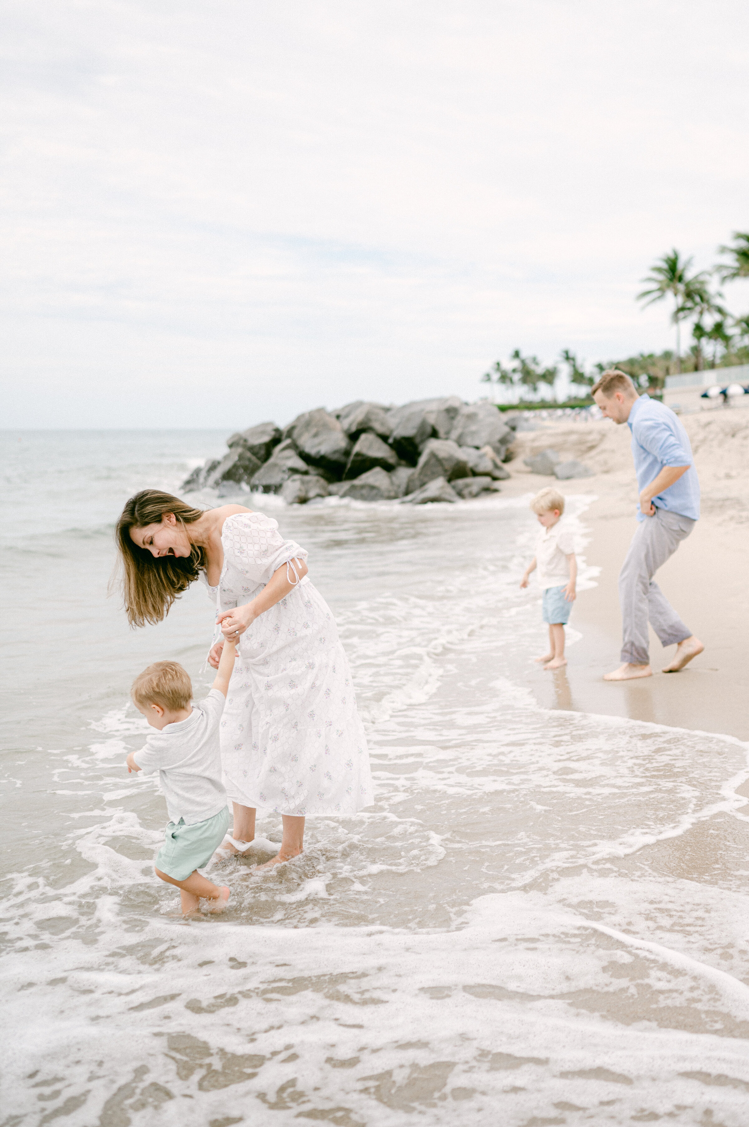 Family of 4 playing on the beach