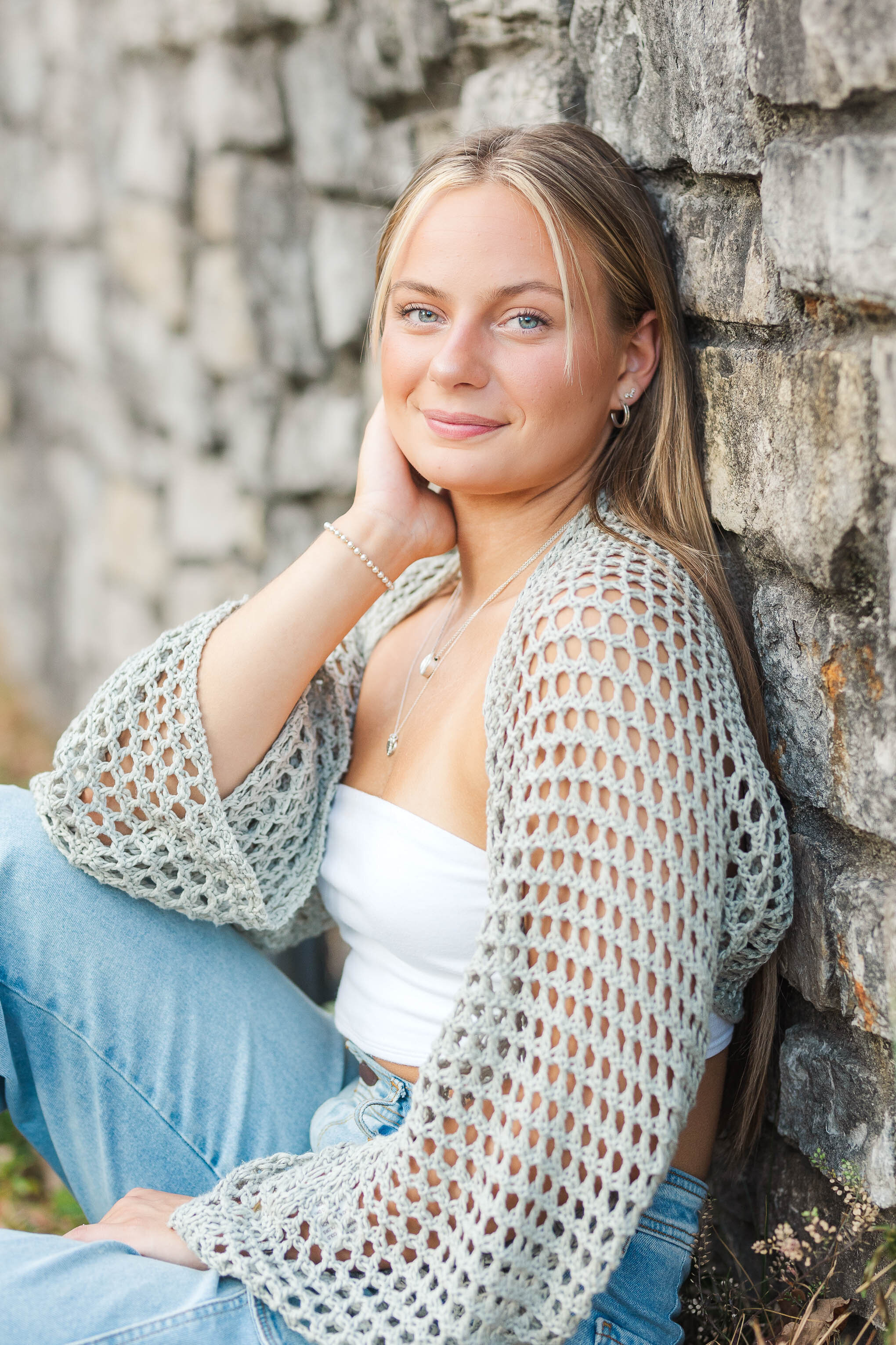 Columbus senior photos at Inniswood Metro Park – a beautiful high school senior sitting by vibrant flowers, captured in natural light for a timeless and elegant portrait.