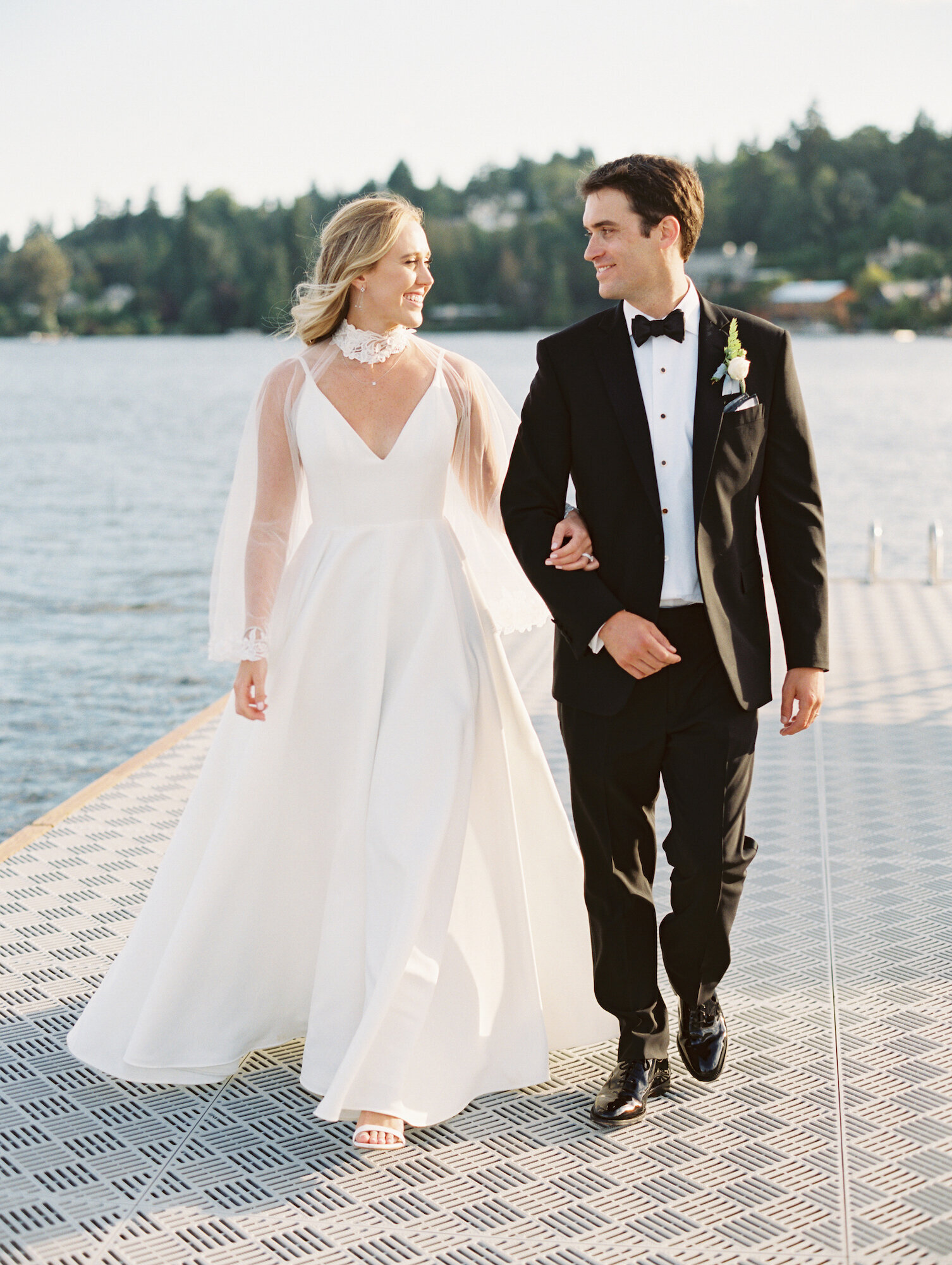 bride and groom walking on dock at seattle tennis club wedding