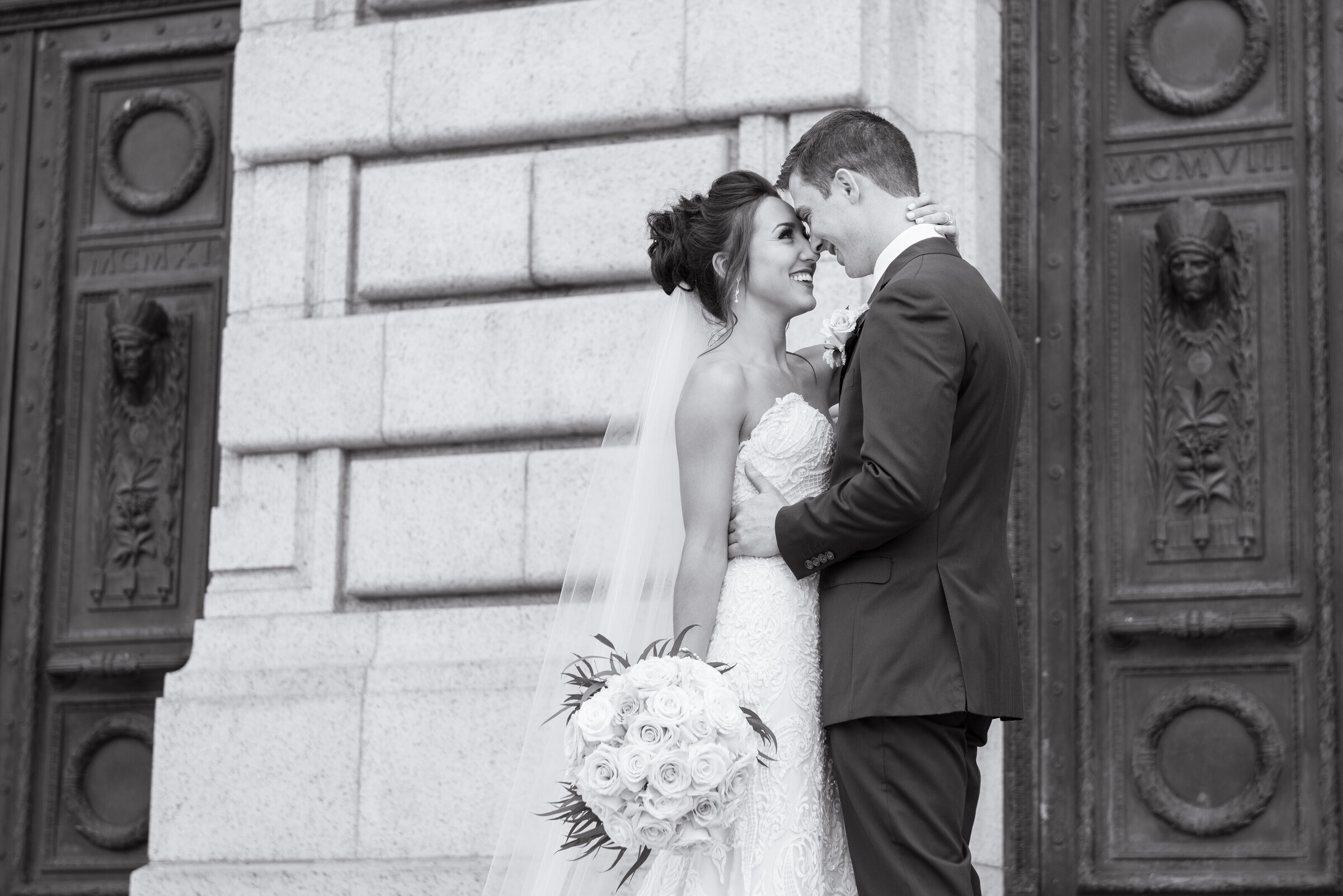 Cleveland bride and groom share in a candid and genuine moment behind The Old Courthouse in Cleveland Ohio on their wedding day. Photo taken by Aaron Aldhizer