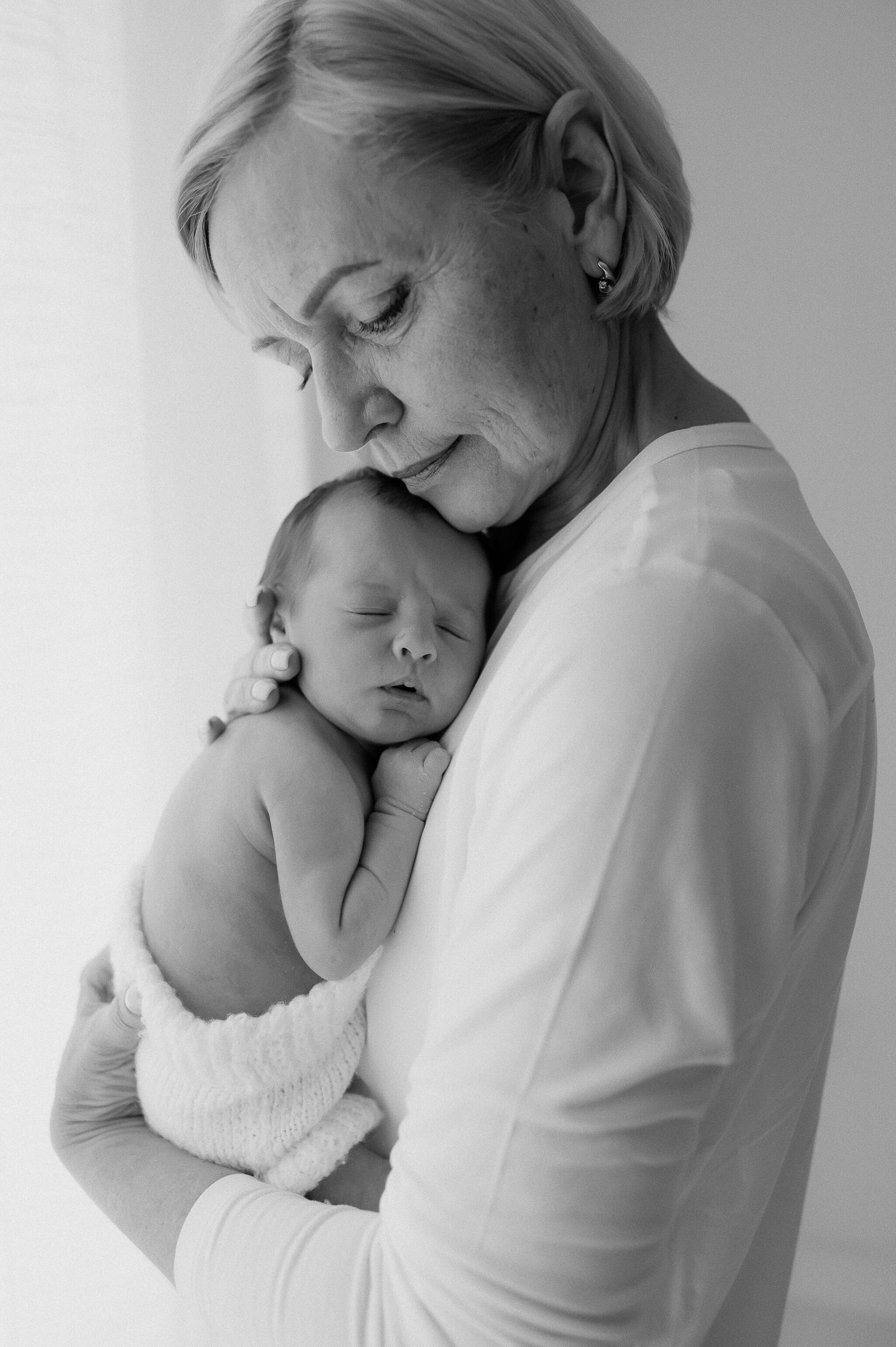 newborn baby girl being held by Grandma at York newborn and baby photography studio in central York, near Leeds, Harrogate and Ripon in Yorkshire