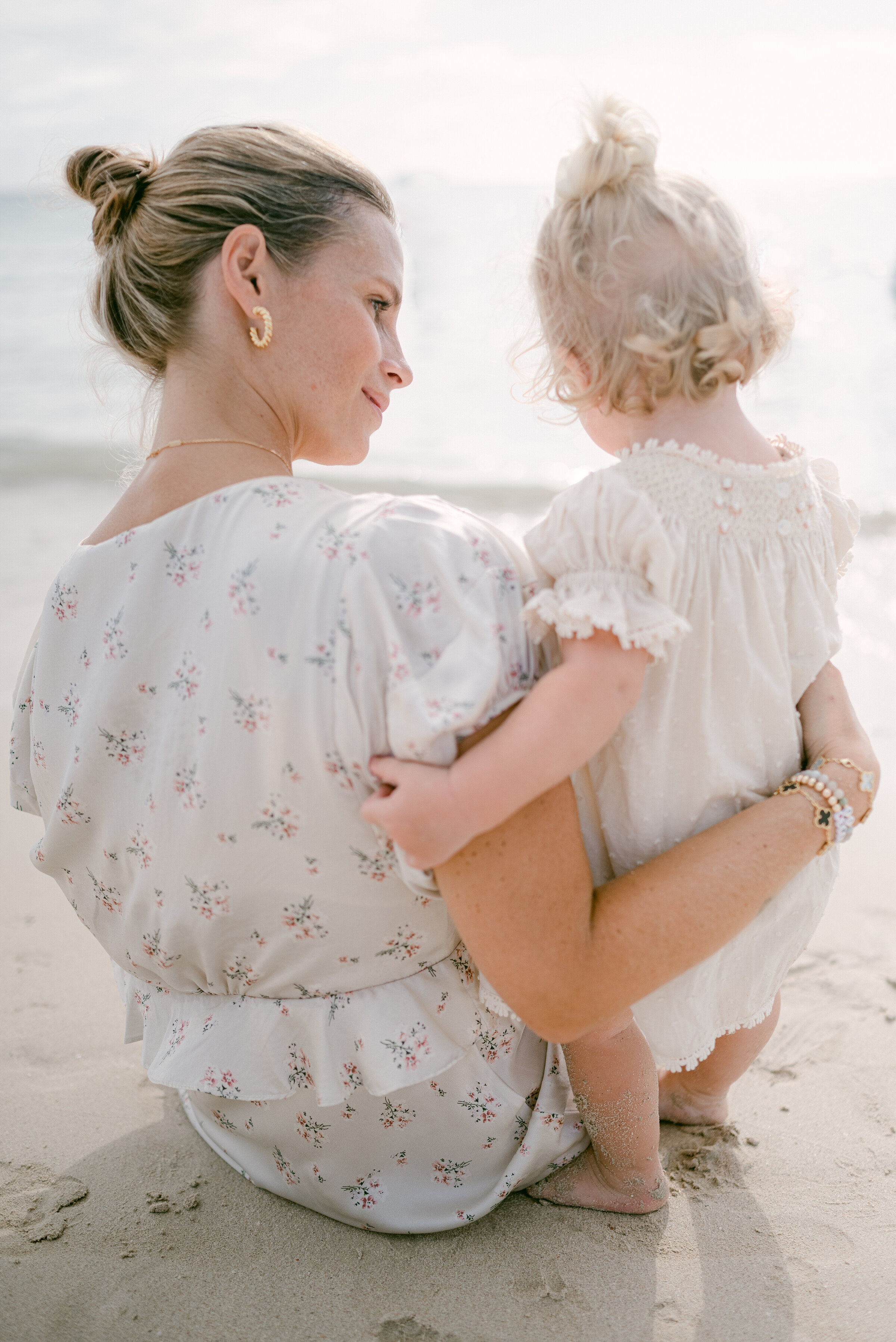 Mom and daughter looking at the horizon by Miami Family Photographer