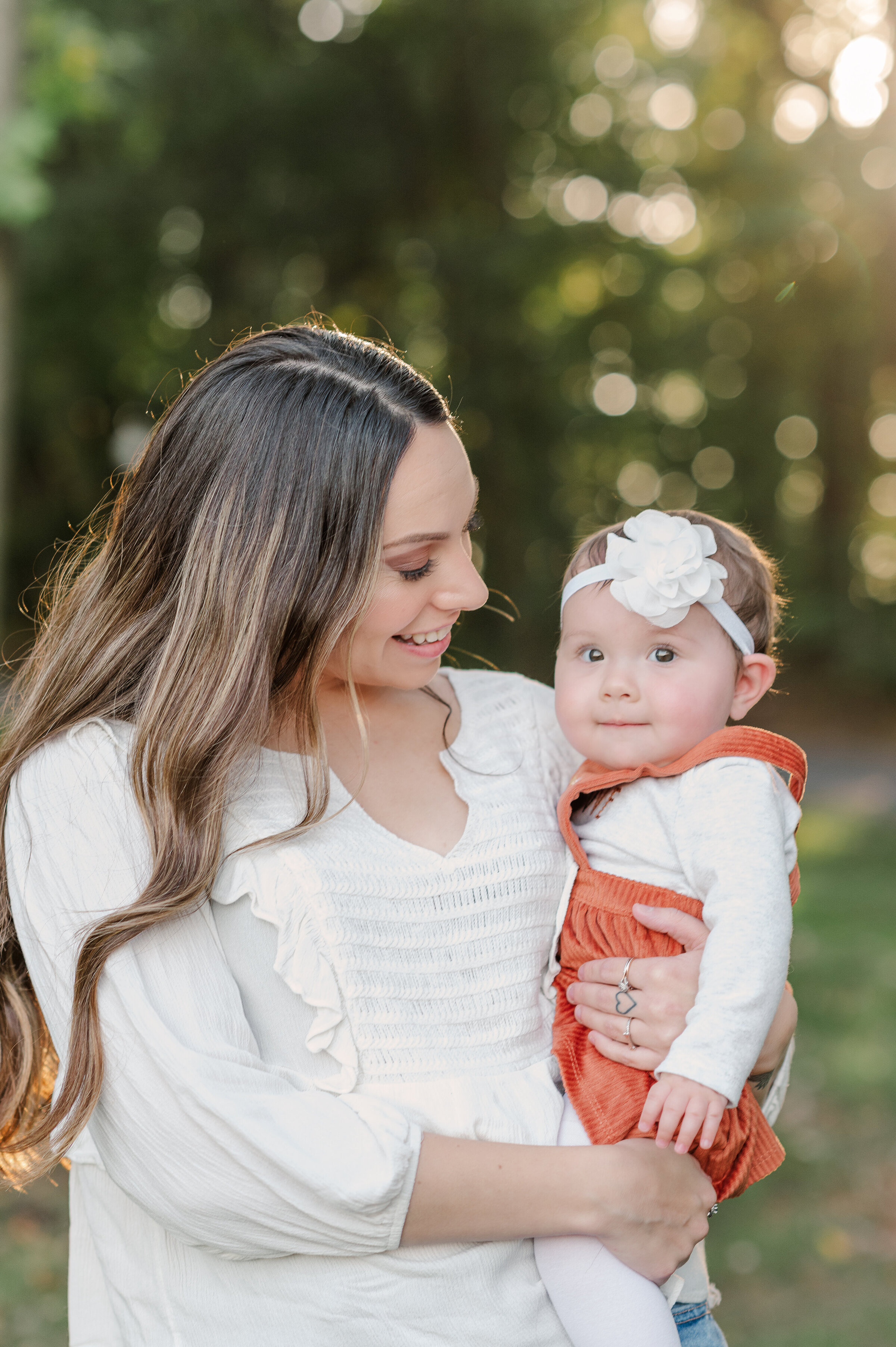 Mom and baby girl laughing during a mommy and me mini session in York, PA at spring valley farms