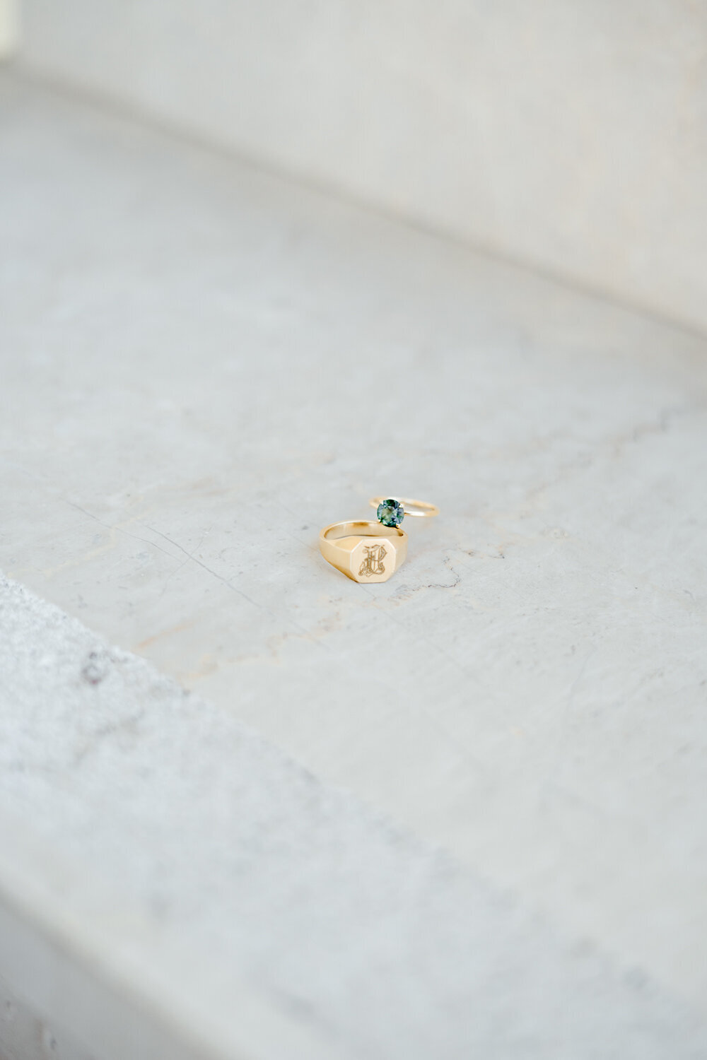 Signet ring and green solitaire ring