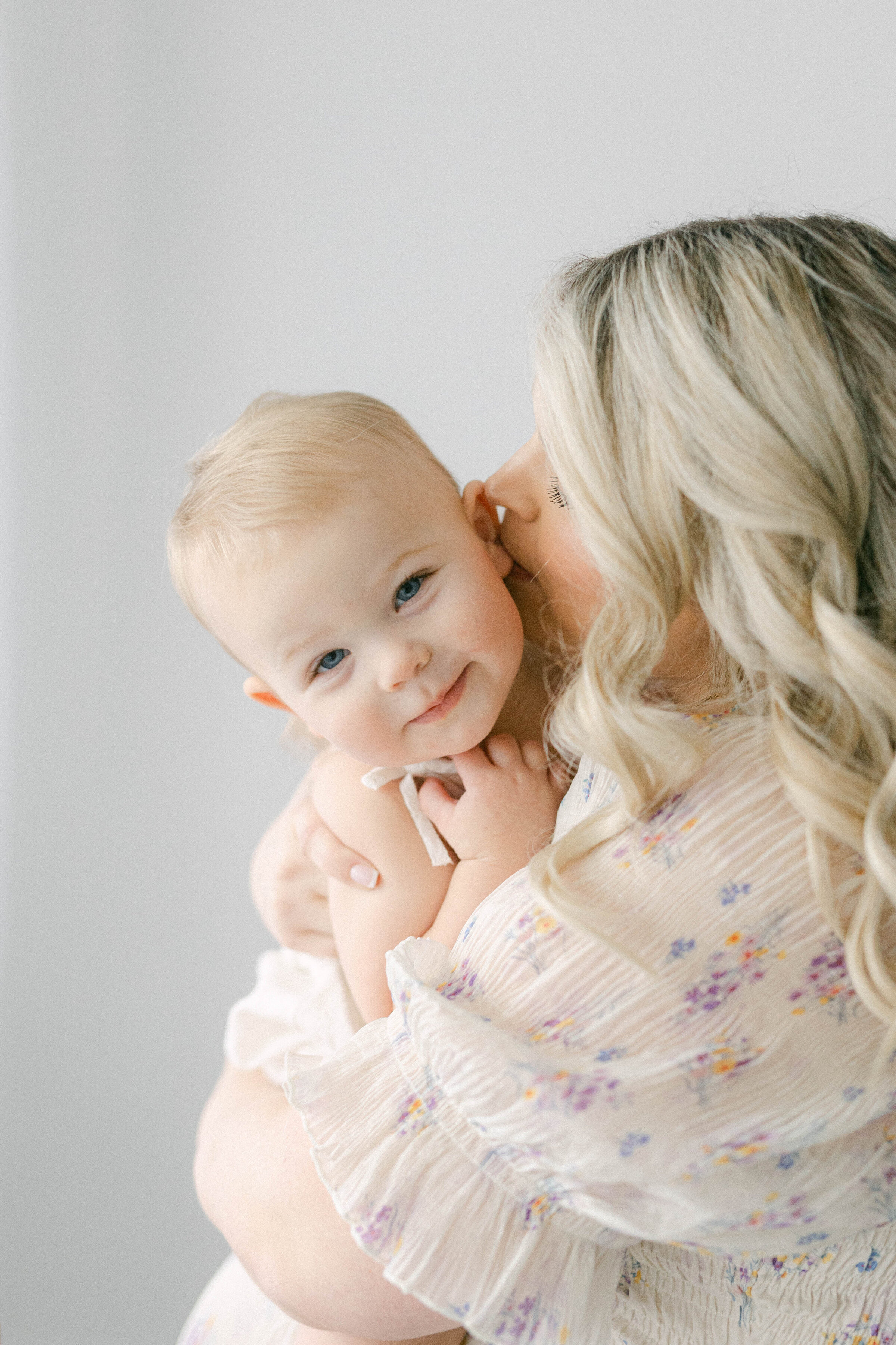 little girl being held by mom smiling at camera knoxville tennessee newborn photographer