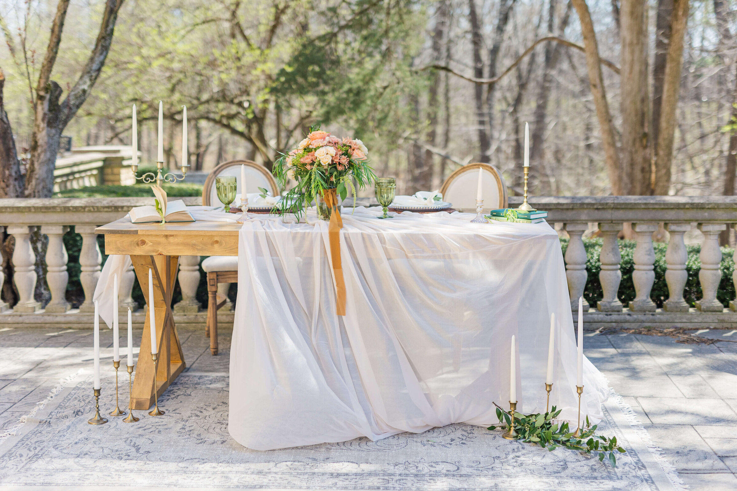 A table with a white table cloth and beautiful wedding florals on it at Laurel Hall