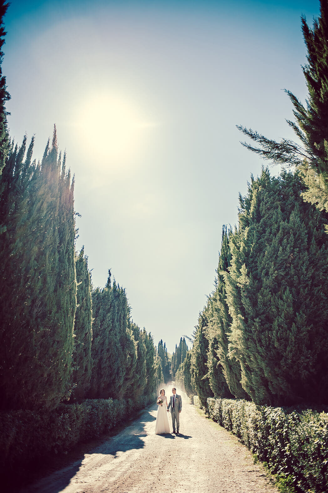 sienna-italy-wedding-couple-walking-trees