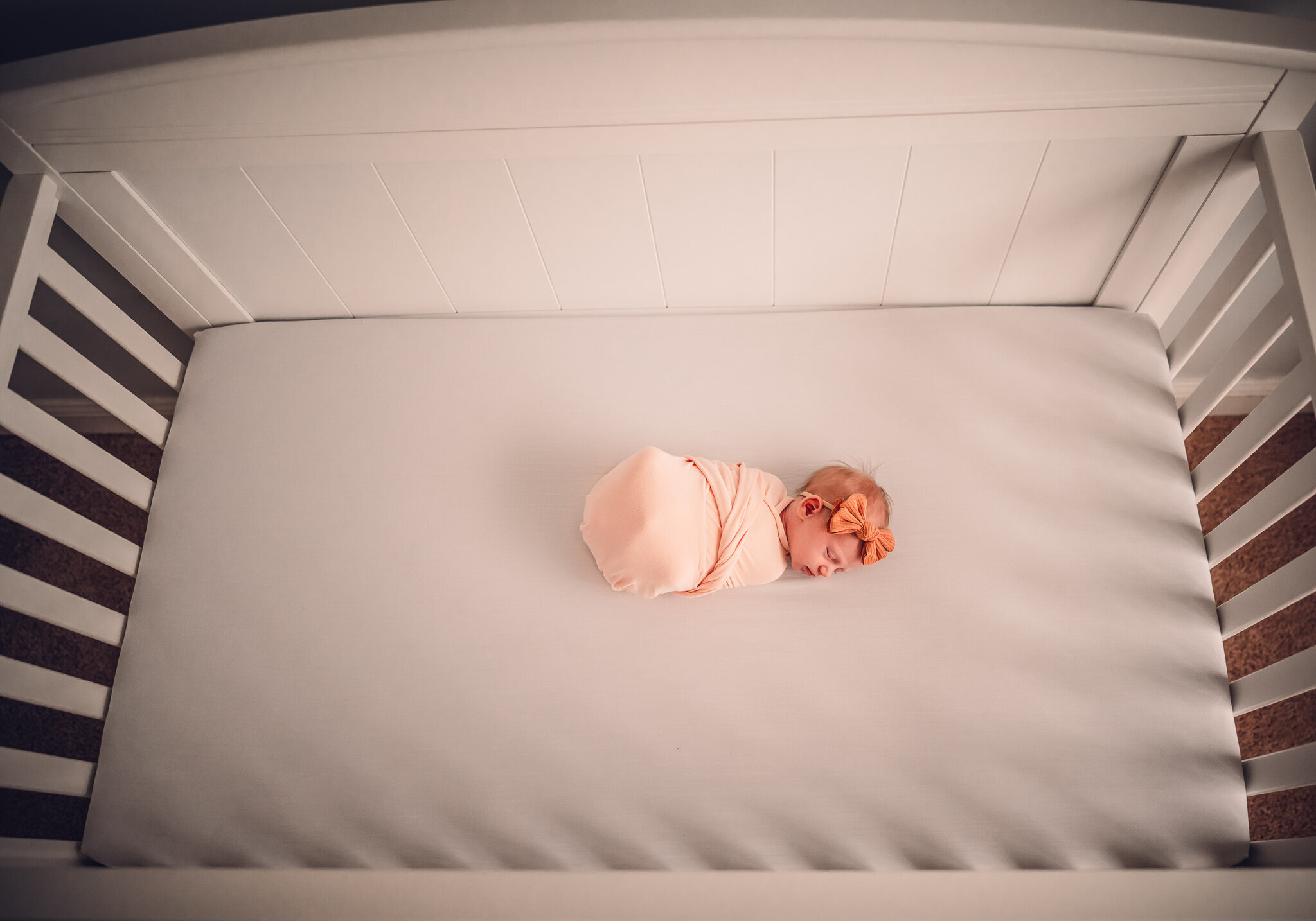 baby girl lying in crib