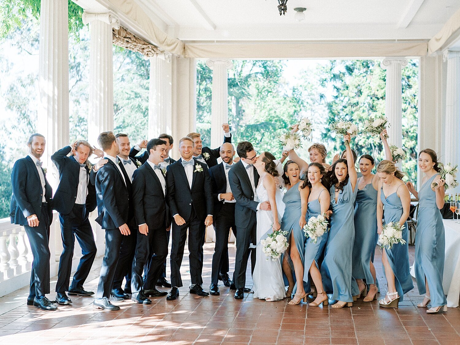 entire bridal party groomsmen and bridesmaids being silly
