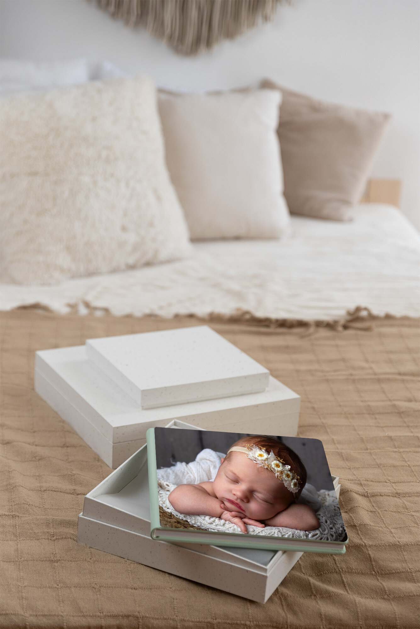 Image of a newborn photo on an heirloom album. The album is on top of the box it can come in.