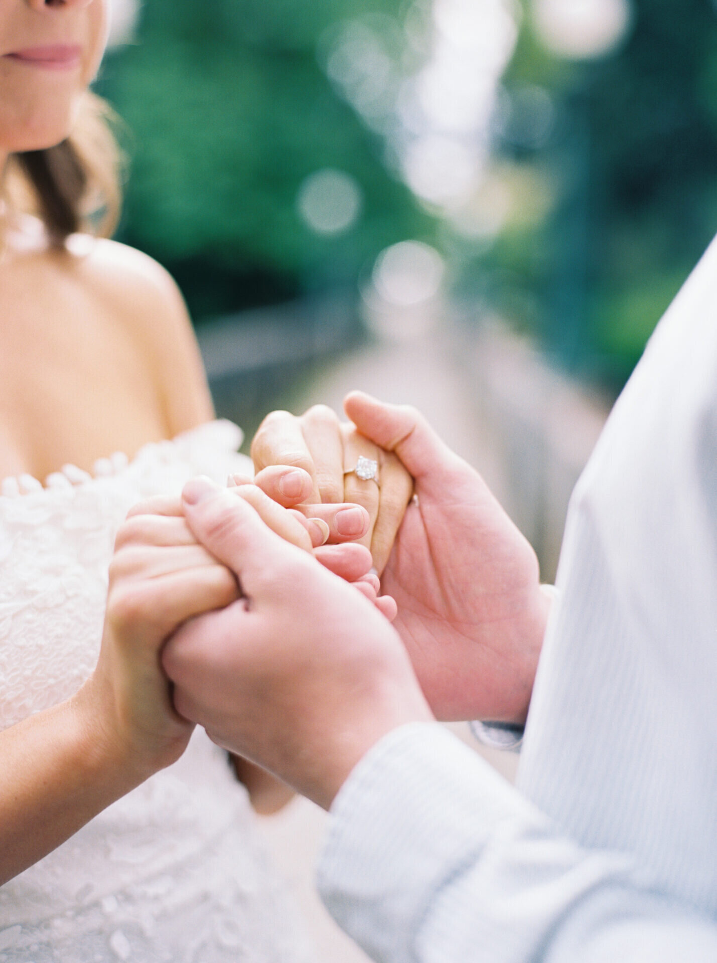 up close photo of diamond engagement ring on ladies hand