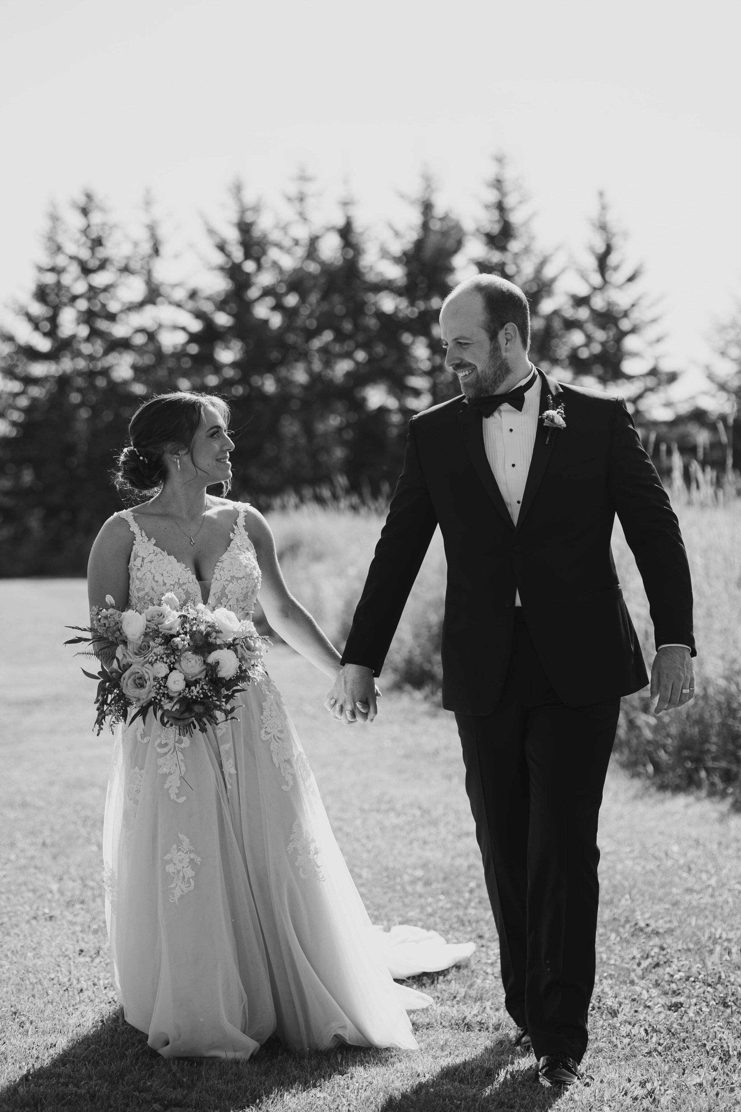 bride and groom posing with bouquet