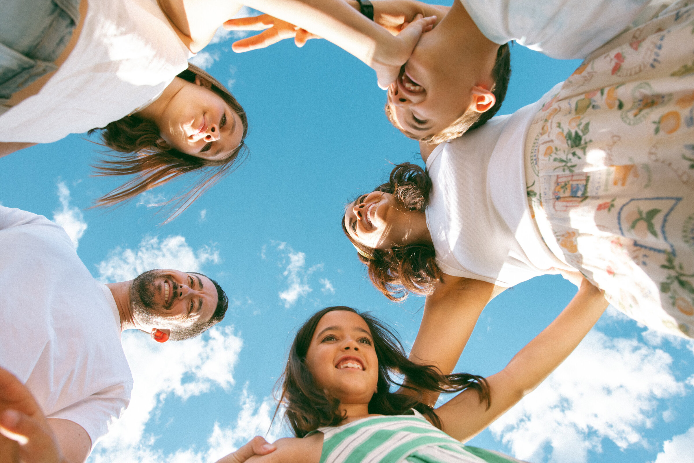photo of a family of five taken from below as they stand smiling over the camera