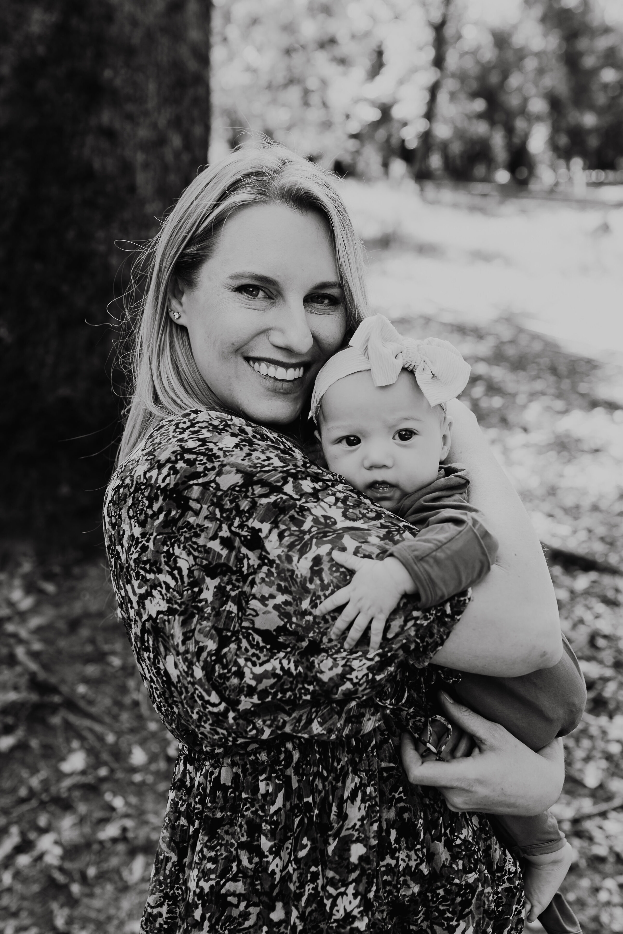 Mom holds her baby close in a black and white photo