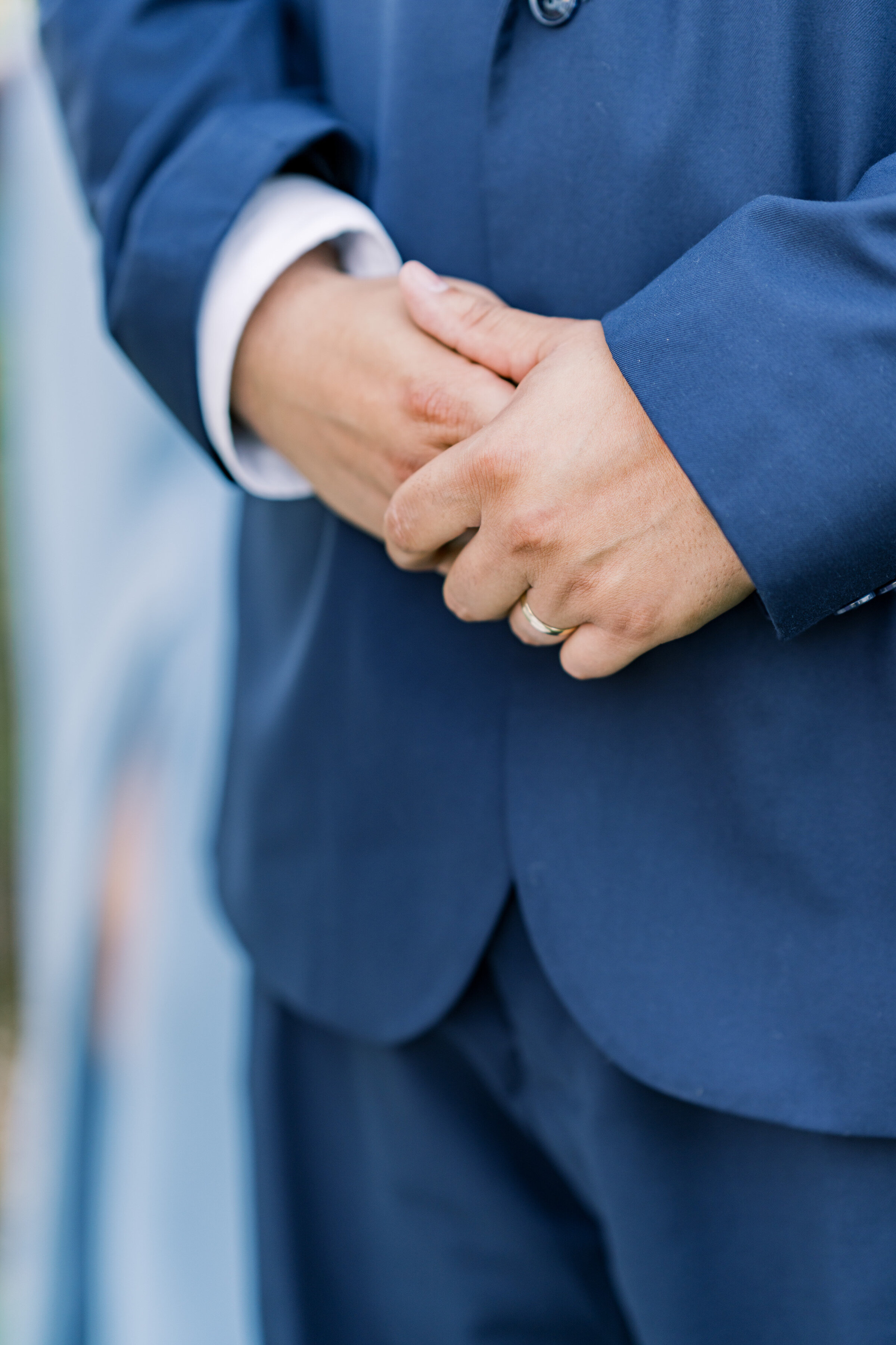 groom-holding-his-hands