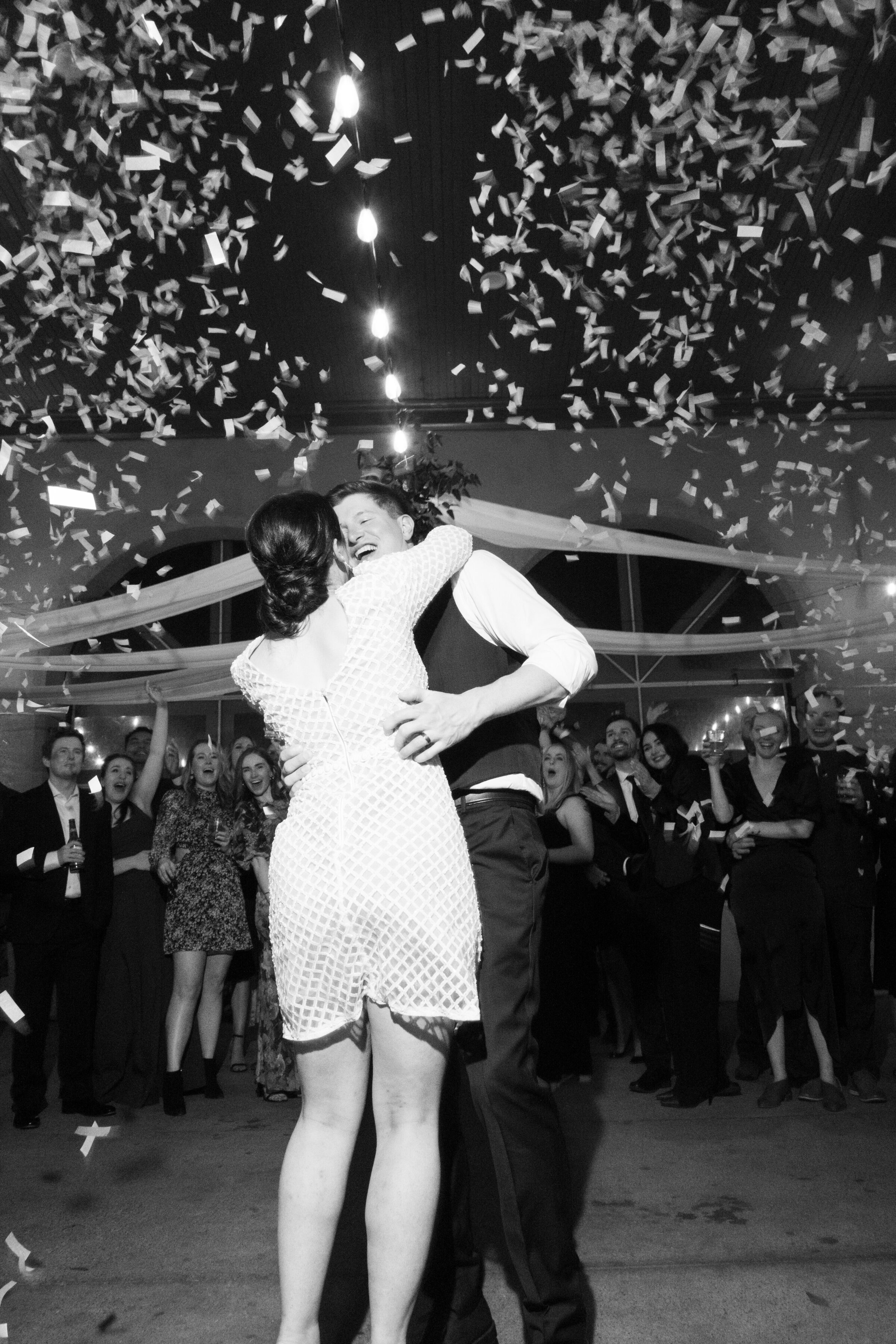 Newlyweds share a celebratory kiss under falling confetti