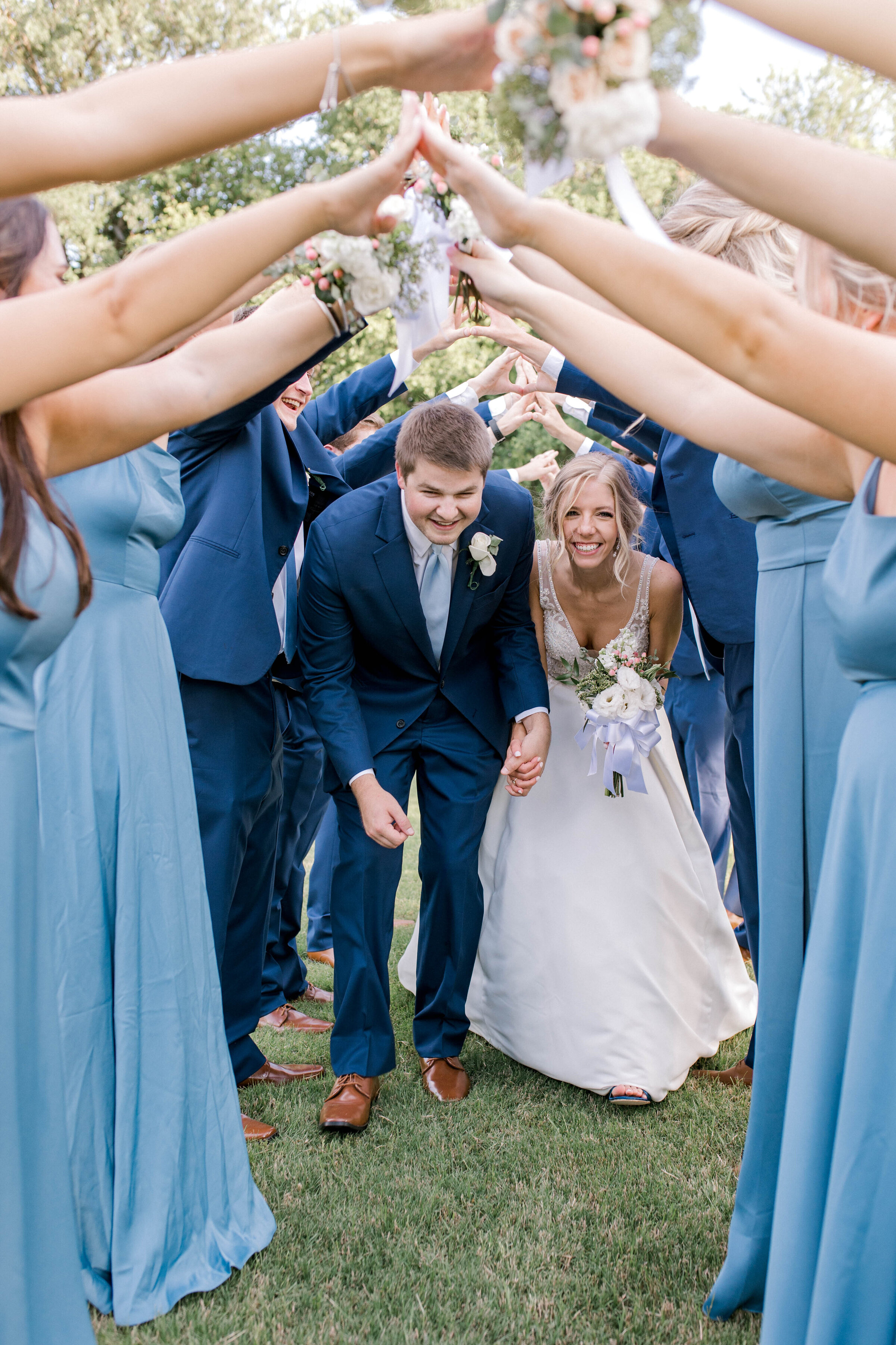 Couple in bridal party tunnel